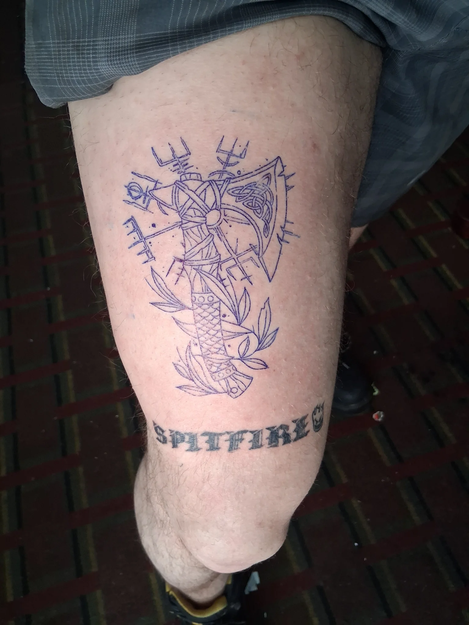 Celtic axe with koi fish and runic symbols tattoo on leg