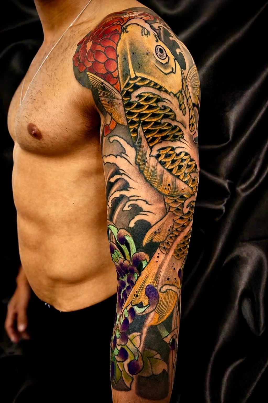 Japanese traditional koi fish full sleeve tattoo with waves and wisteria