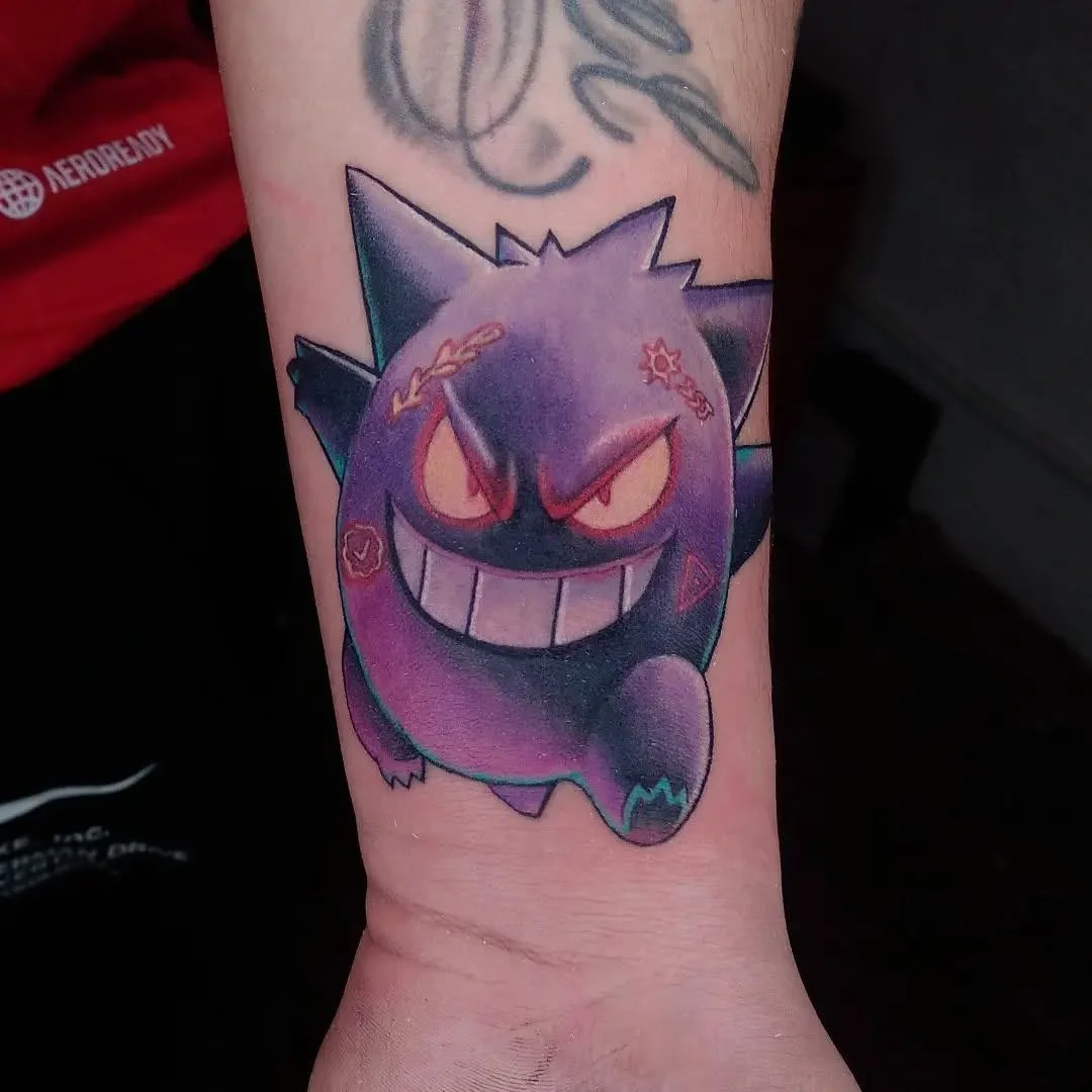 Colorful Gengar Pokemon tattoo on the wrist