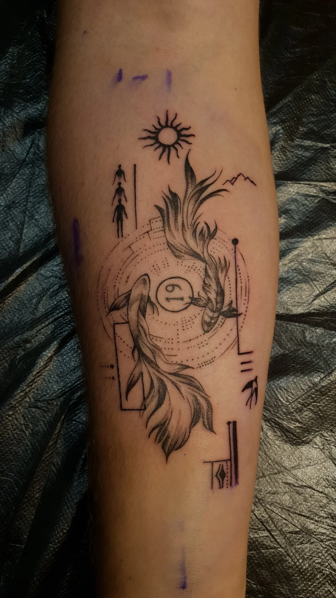 Fine line Pisces and phoenix forearm tattoo with geometric elements