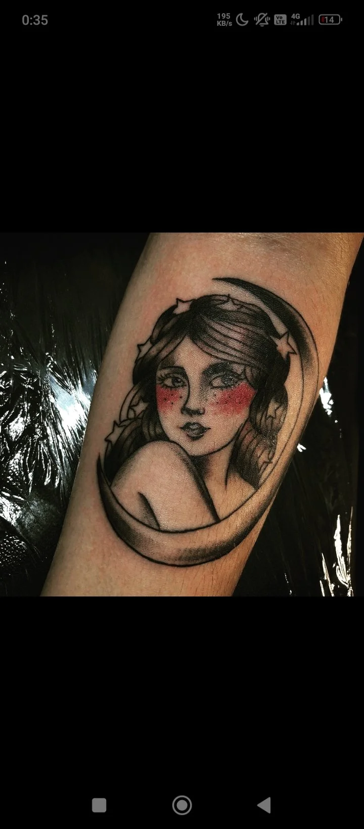 Neo-traditional woman in crescent moon tattoo on forearm