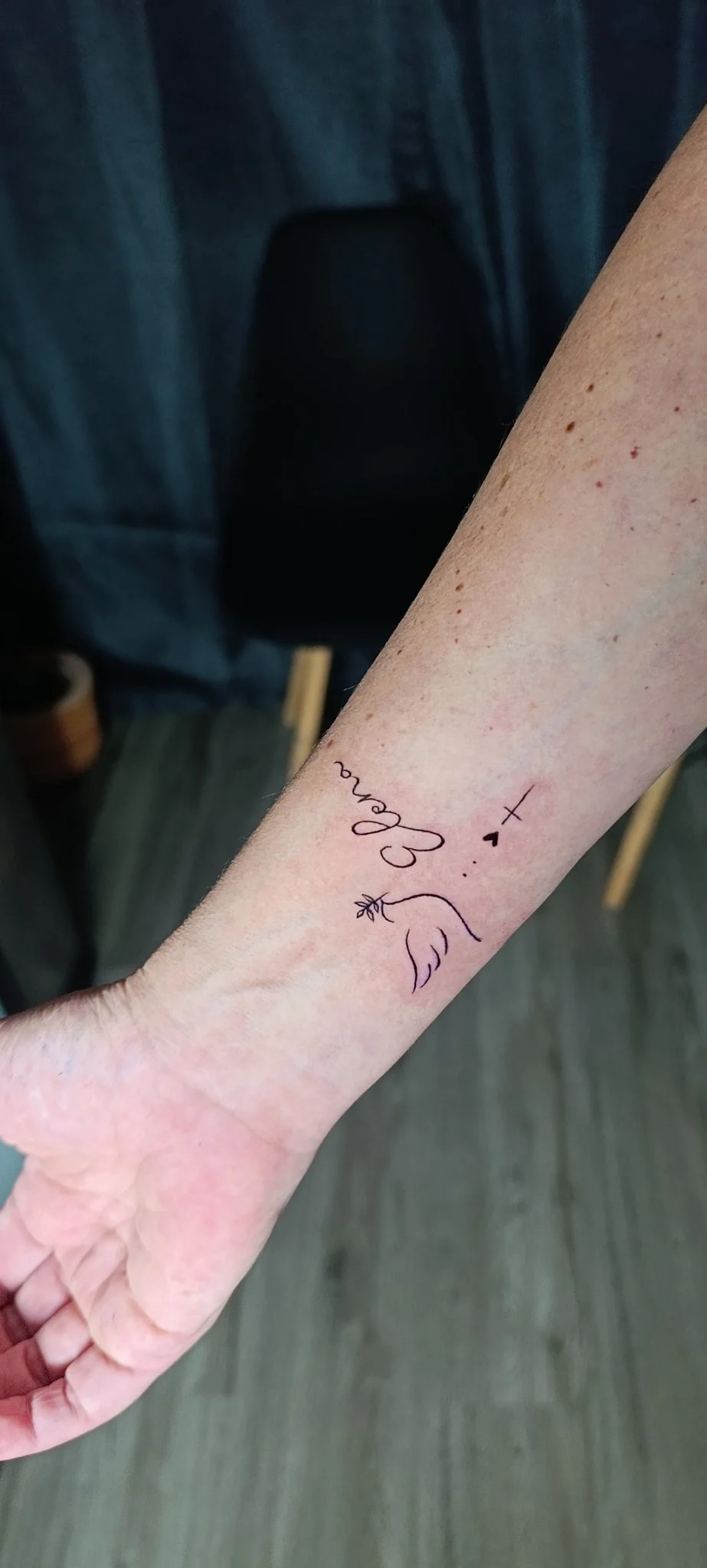 Fine line script name and dove tattoo on inner wrist