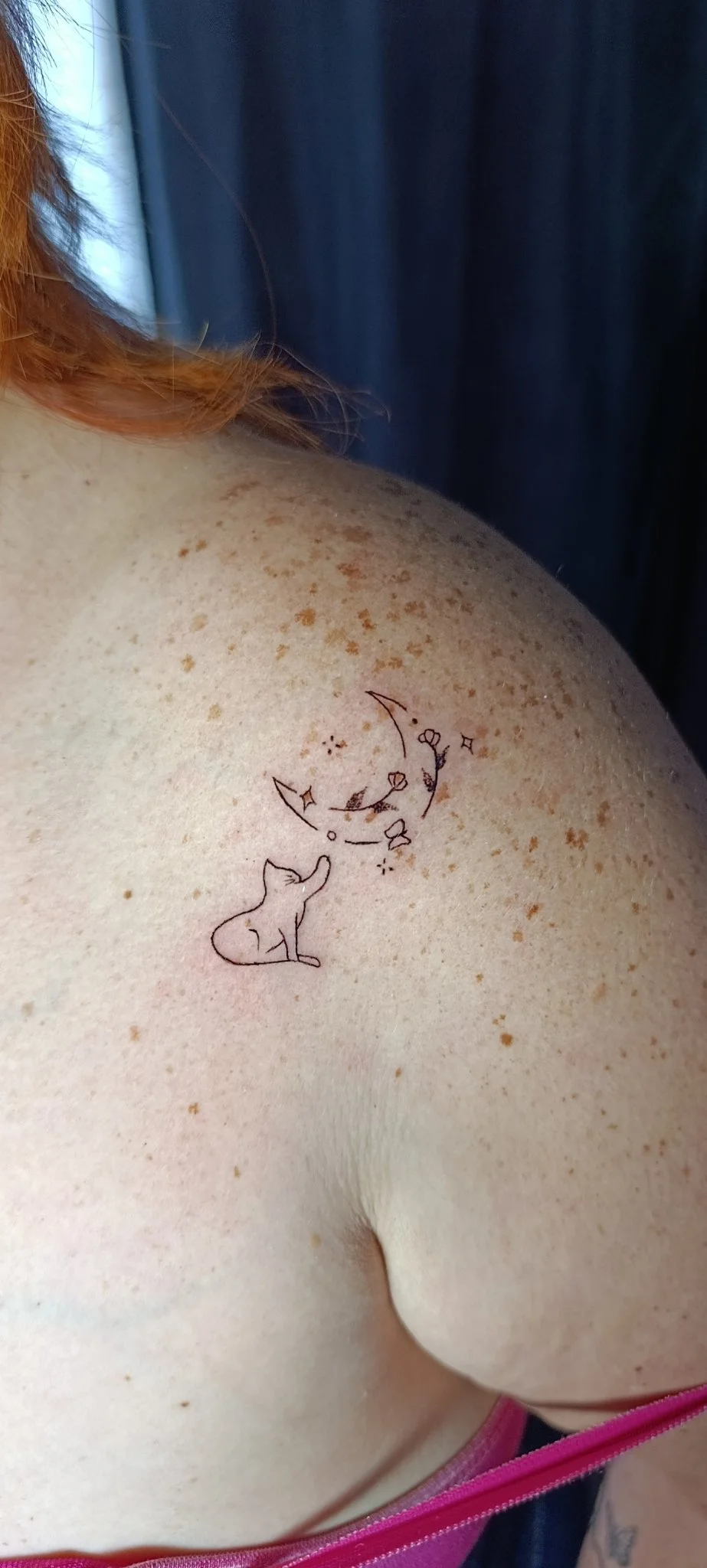 Fine line cat gazing at floral crescent moon on shoulder