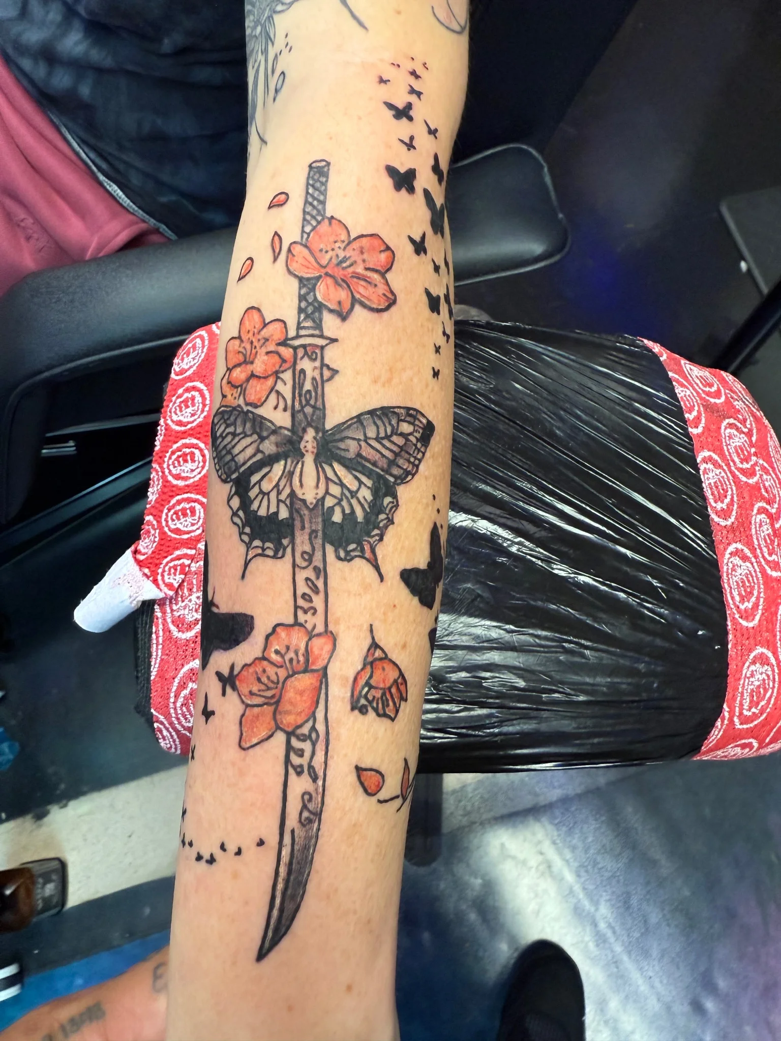 Neo-traditional katana with butterfly and orange blossoms on forearm
