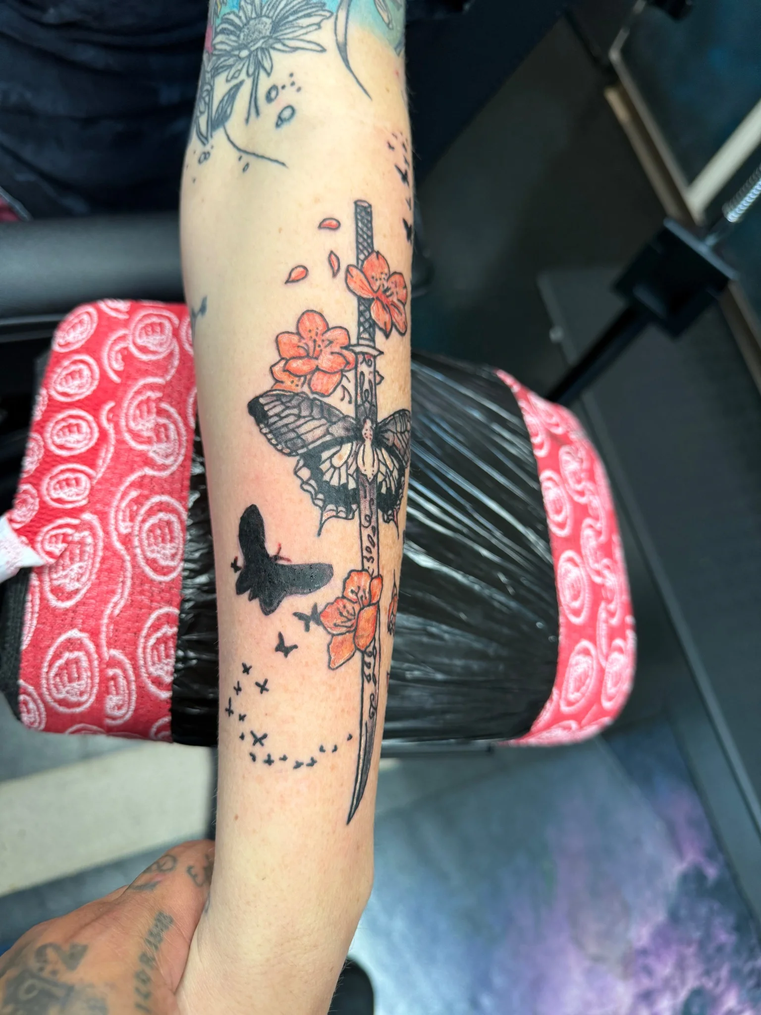 Neo-traditional katana with butterfly and cherry blossoms on forearm