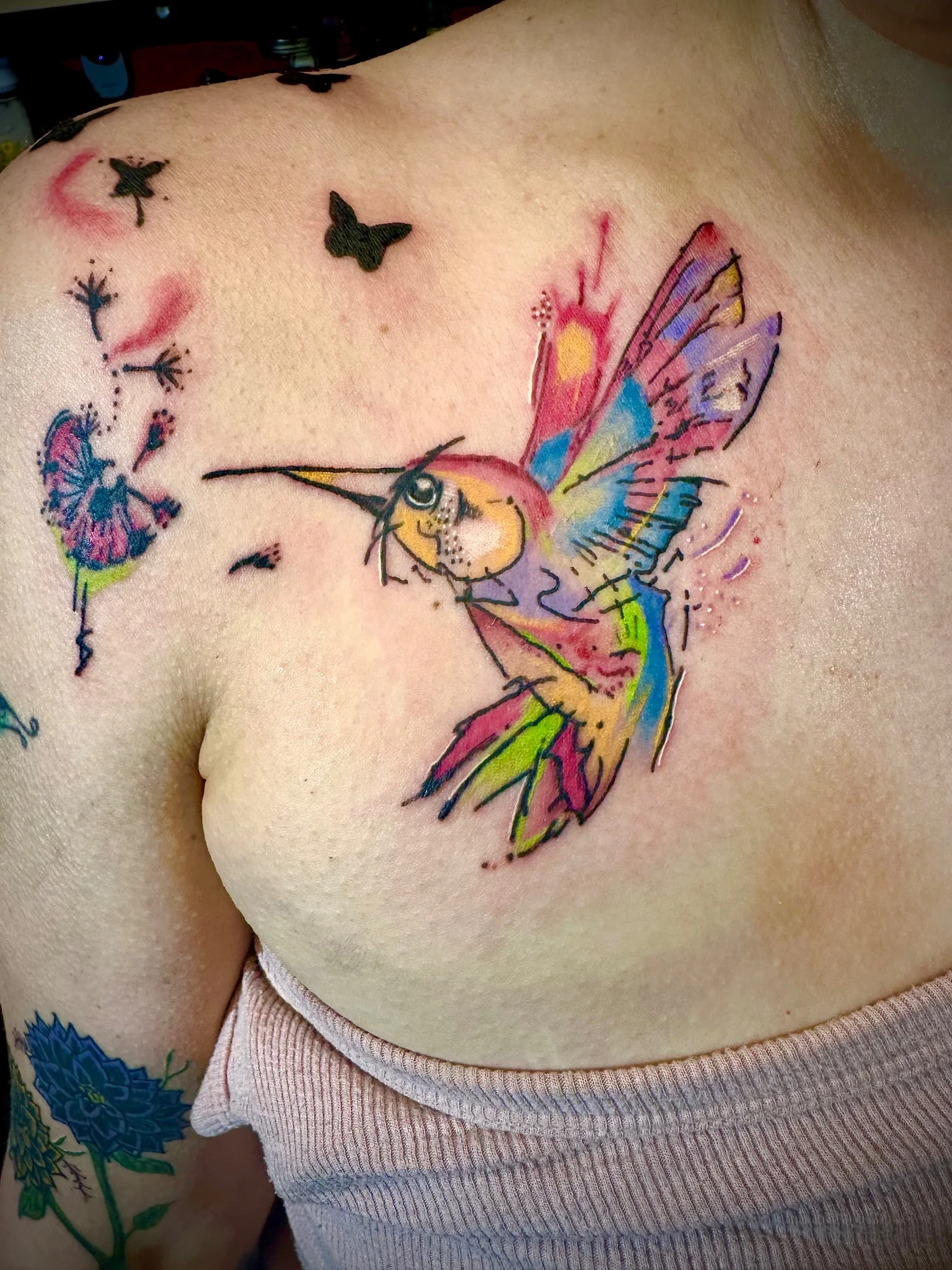 Watercolor hummingbird with butterflies and dandelion on chest