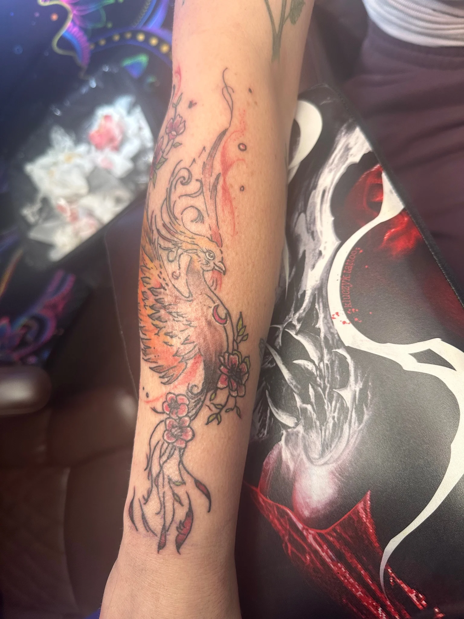 Neo-traditional phoenix with cherry blossoms tattoo on forearm