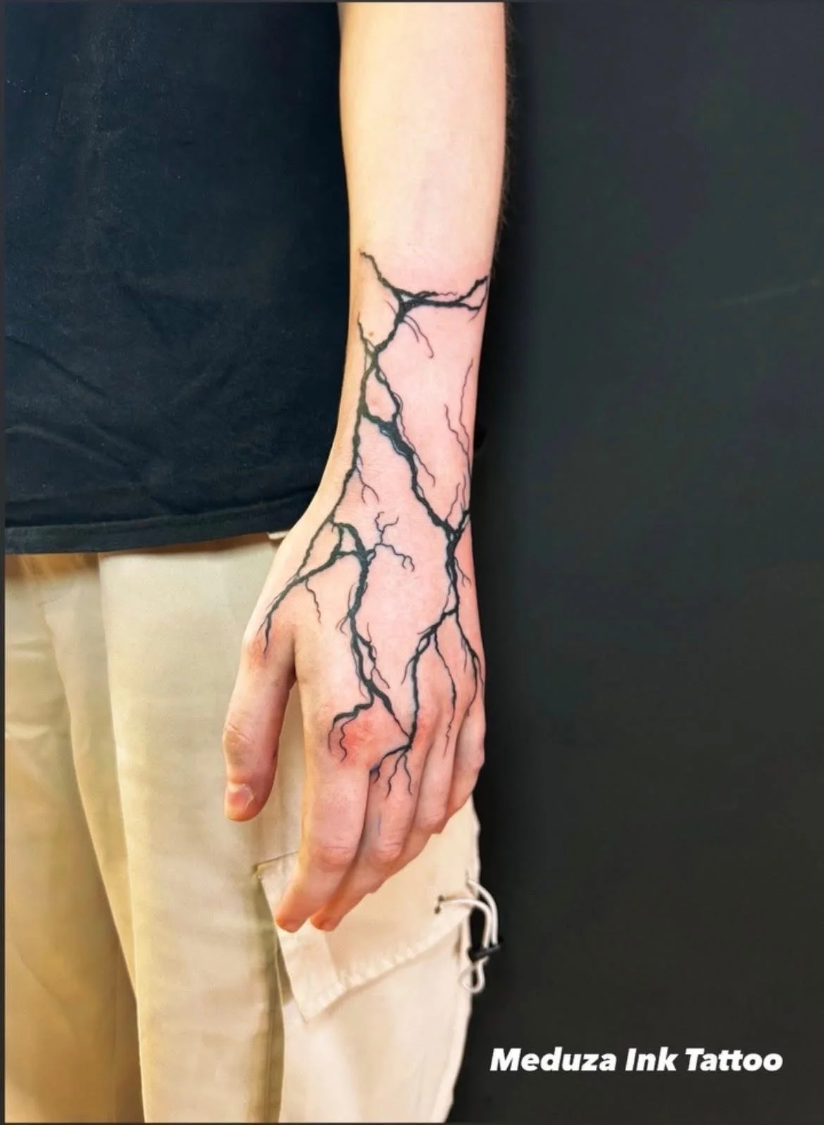 Fine line lightning bolt branch tattoo on hand and wrist