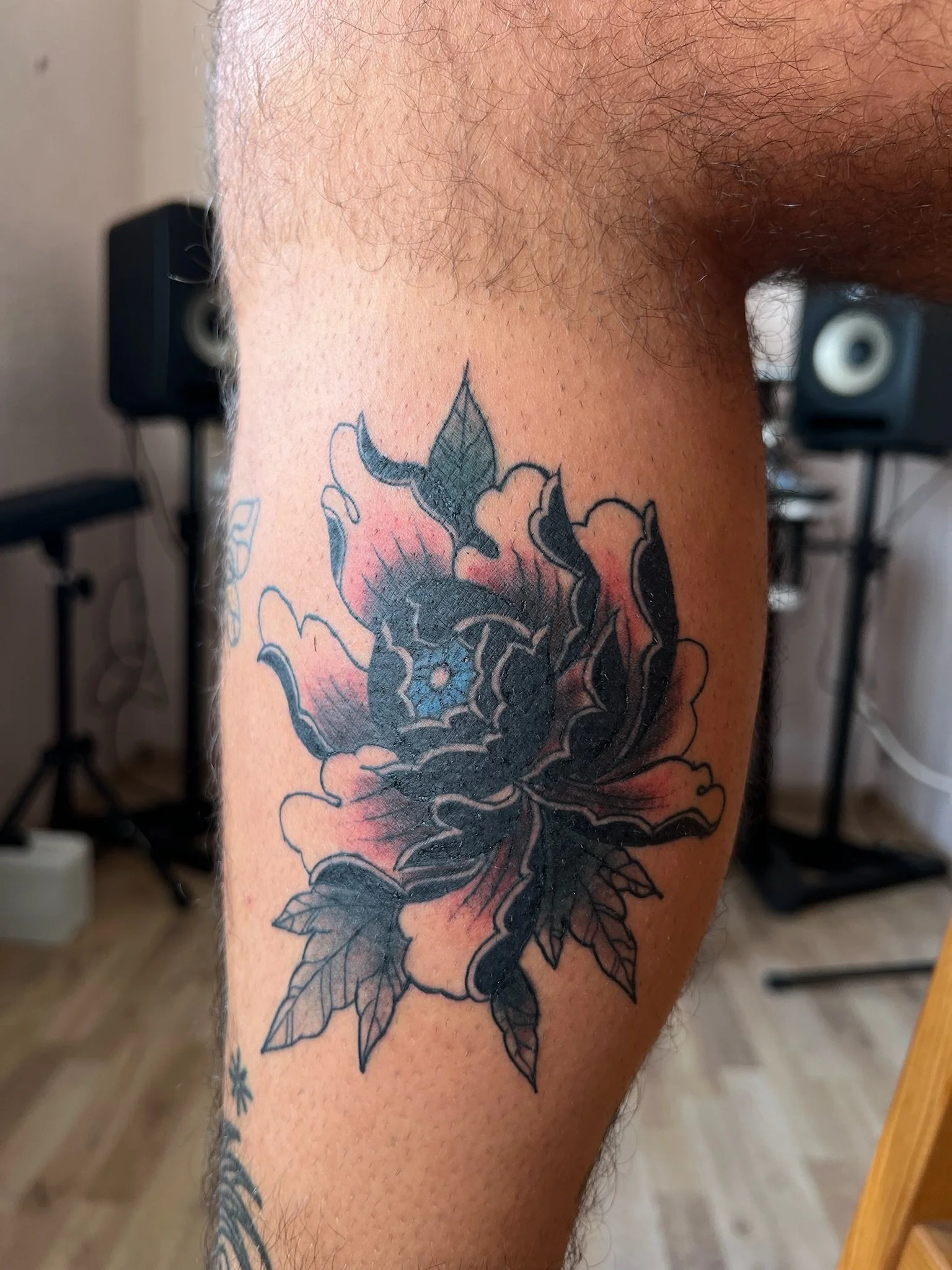 Neo-traditional peony flower tattoo on lower leg