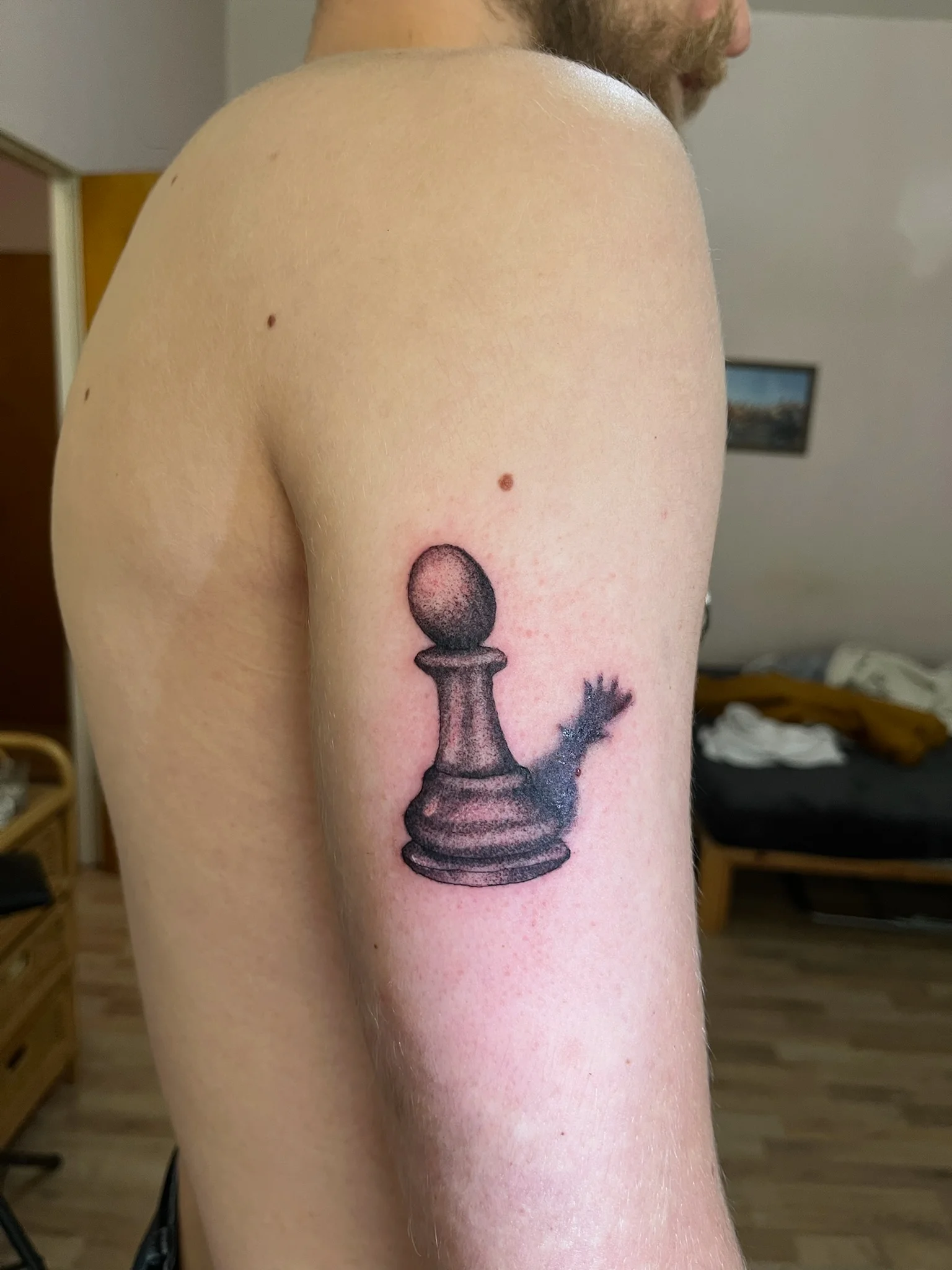 Dotwork chess pawn with king crown shadow on upper arm