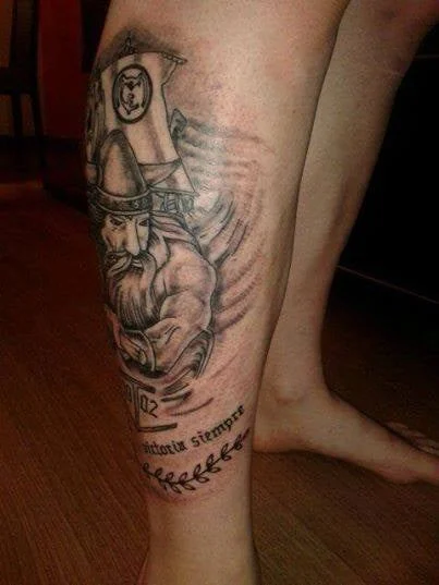 Black and grey viking warrior tattoo with script on calf