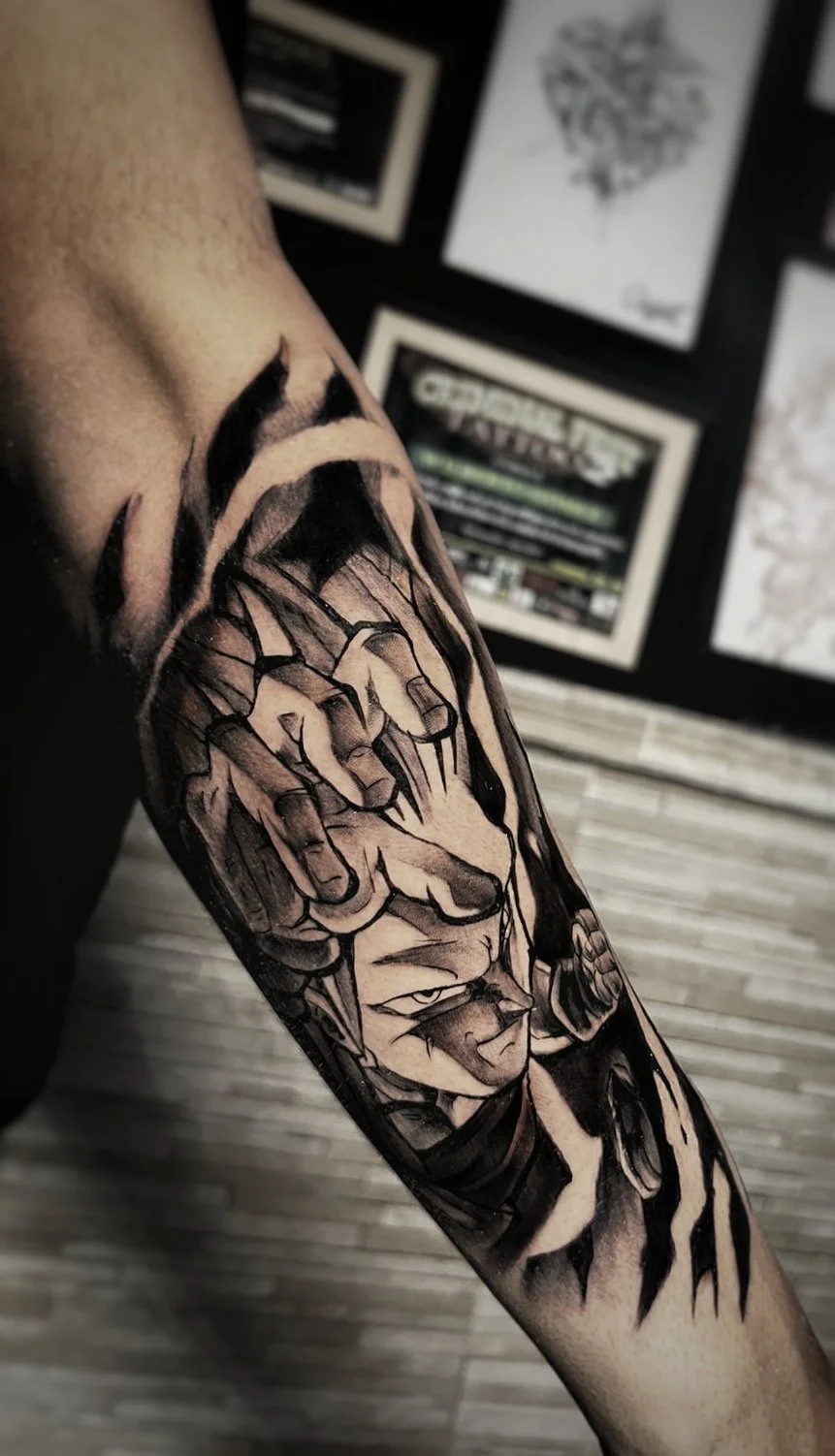 Black and grey anime character forearm tattoo with dramatic hands