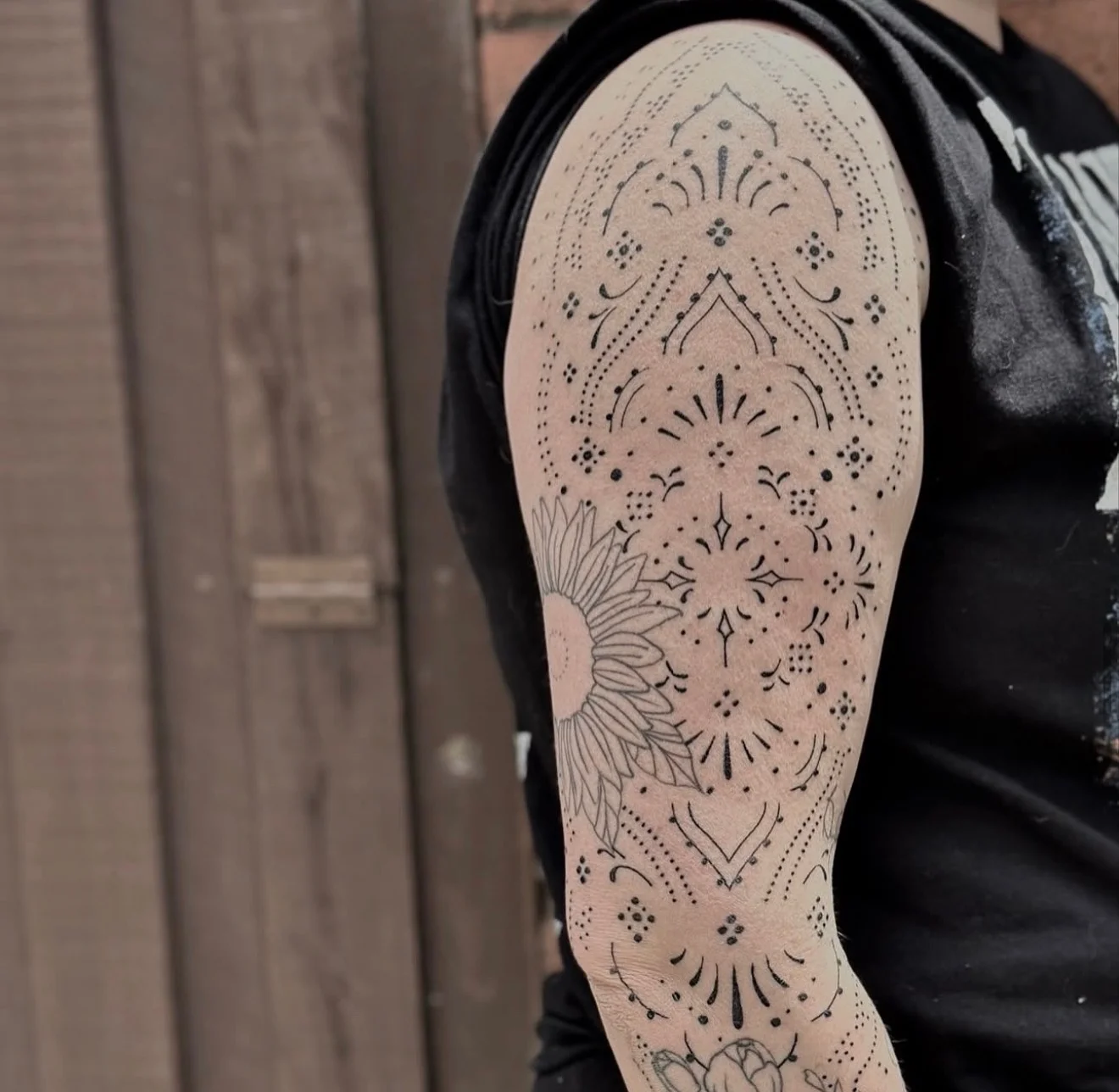 Ornamental mandala and sunflower tattoo on upper arm sleeve