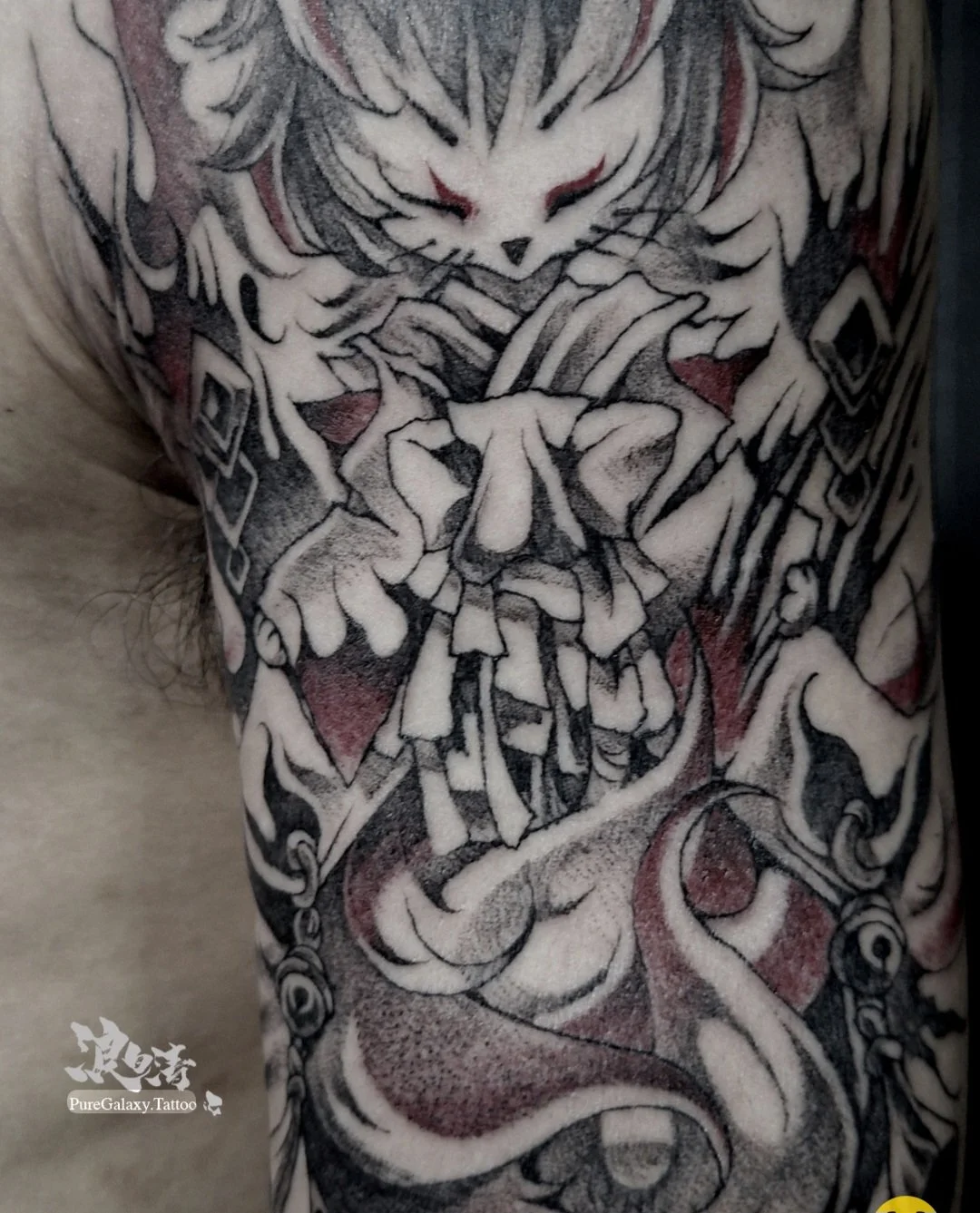 Black grey and red oni demon tattoo on chest and arm