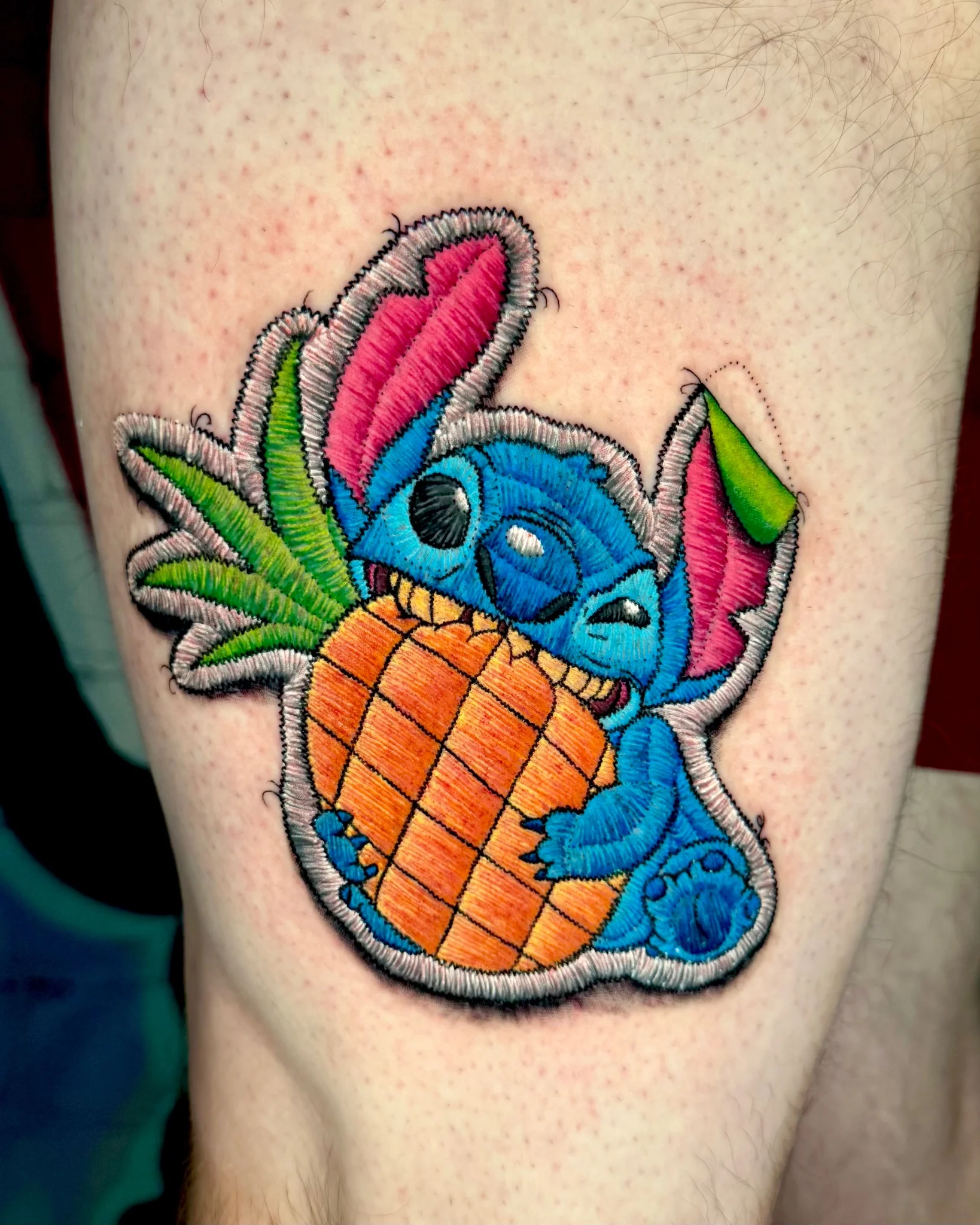 Embroidery-style Stitch with pineapple tattoo on leg