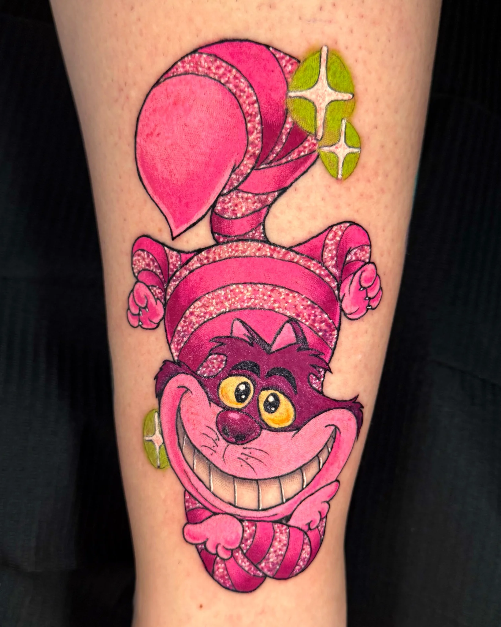 Vibrant new school Cheshire Cat tattoo on lower leg
