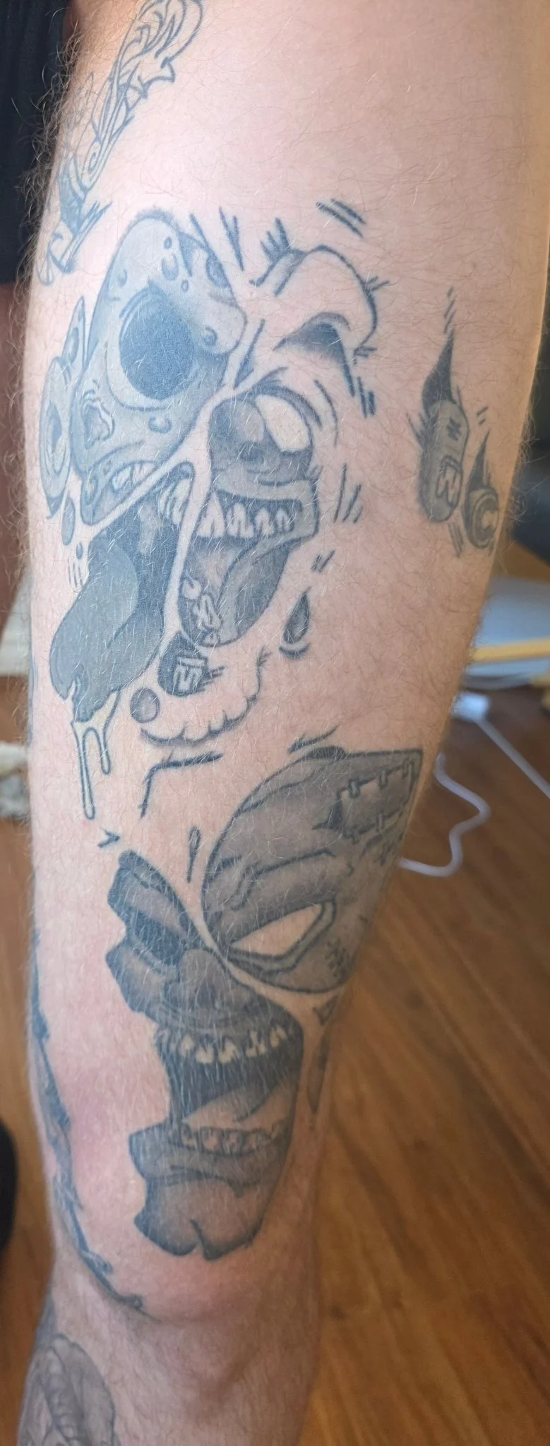 Black and grey new school clown skull and butterfly on forearm