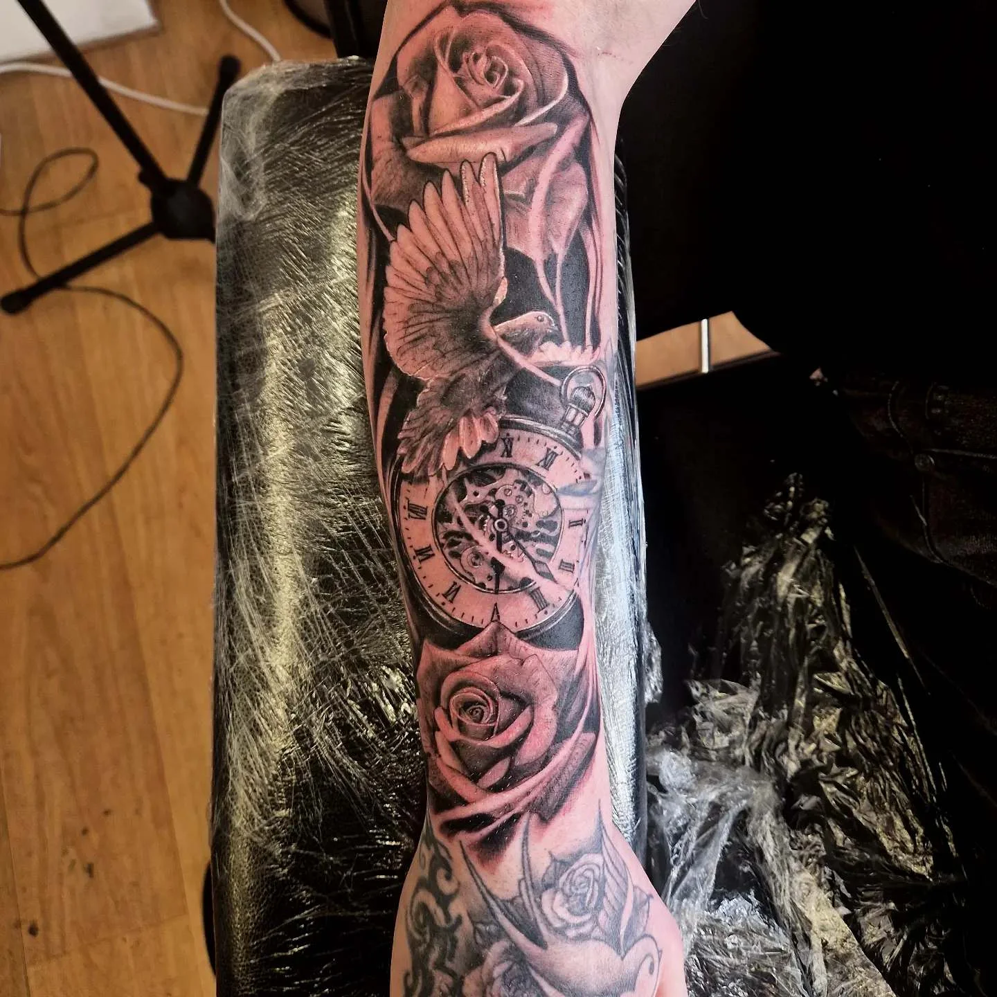 Black and grey realism sleeve with roses, dove, and pocket watch