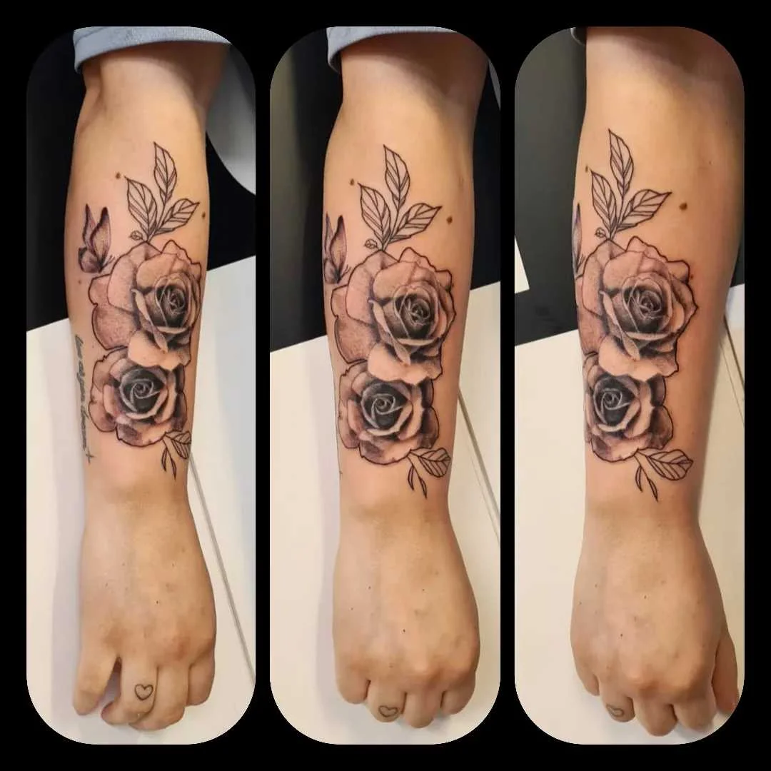 Black and grey double rose floral tattoo on forearm