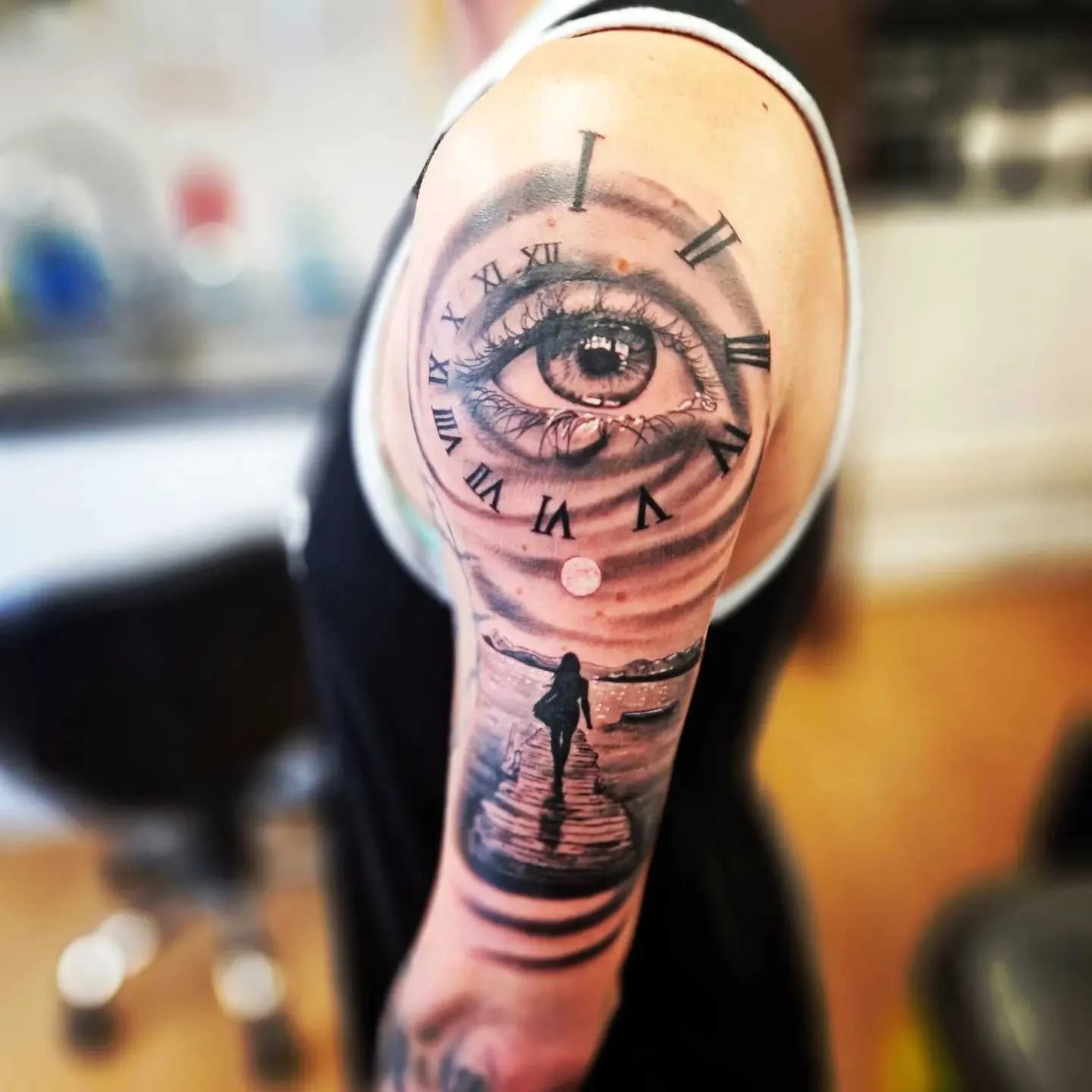 Black and grey realism eye and clock tattoo on upper arm