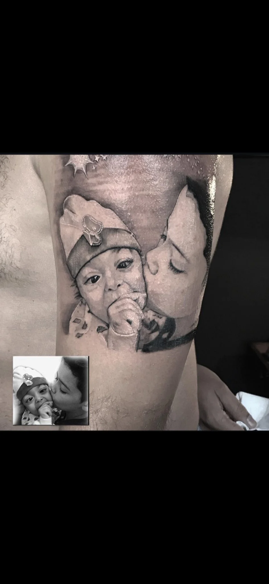 Black and grey realism portrait of mother and baby on arm