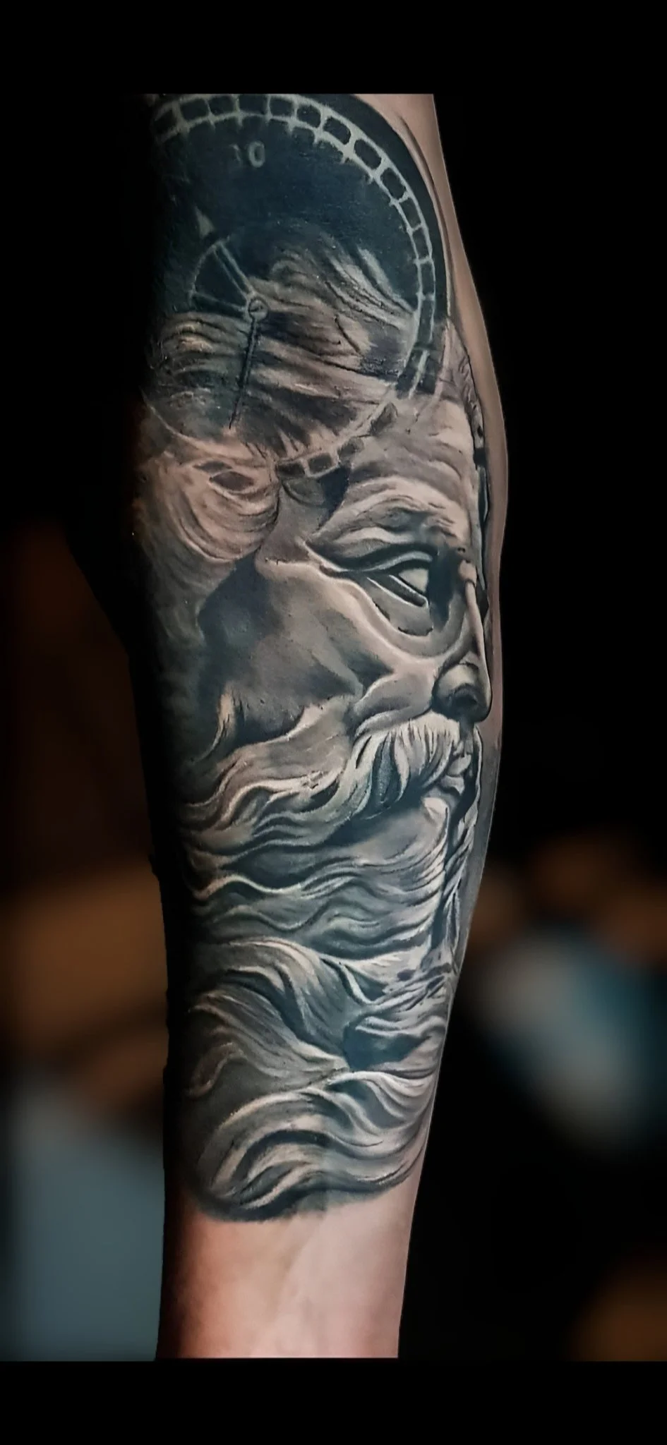 Black and grey realism Poseidon with compass tattoo on forearm