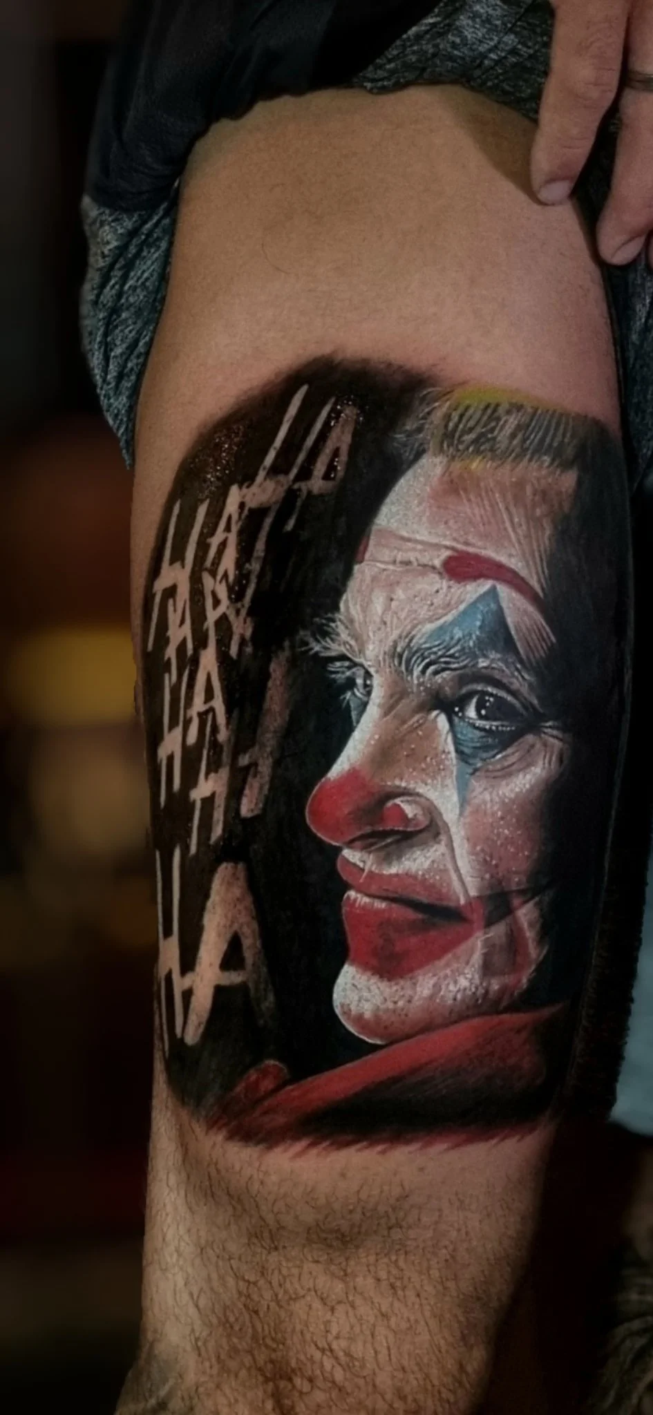Color realism Joker portrait tattoo on upper leg