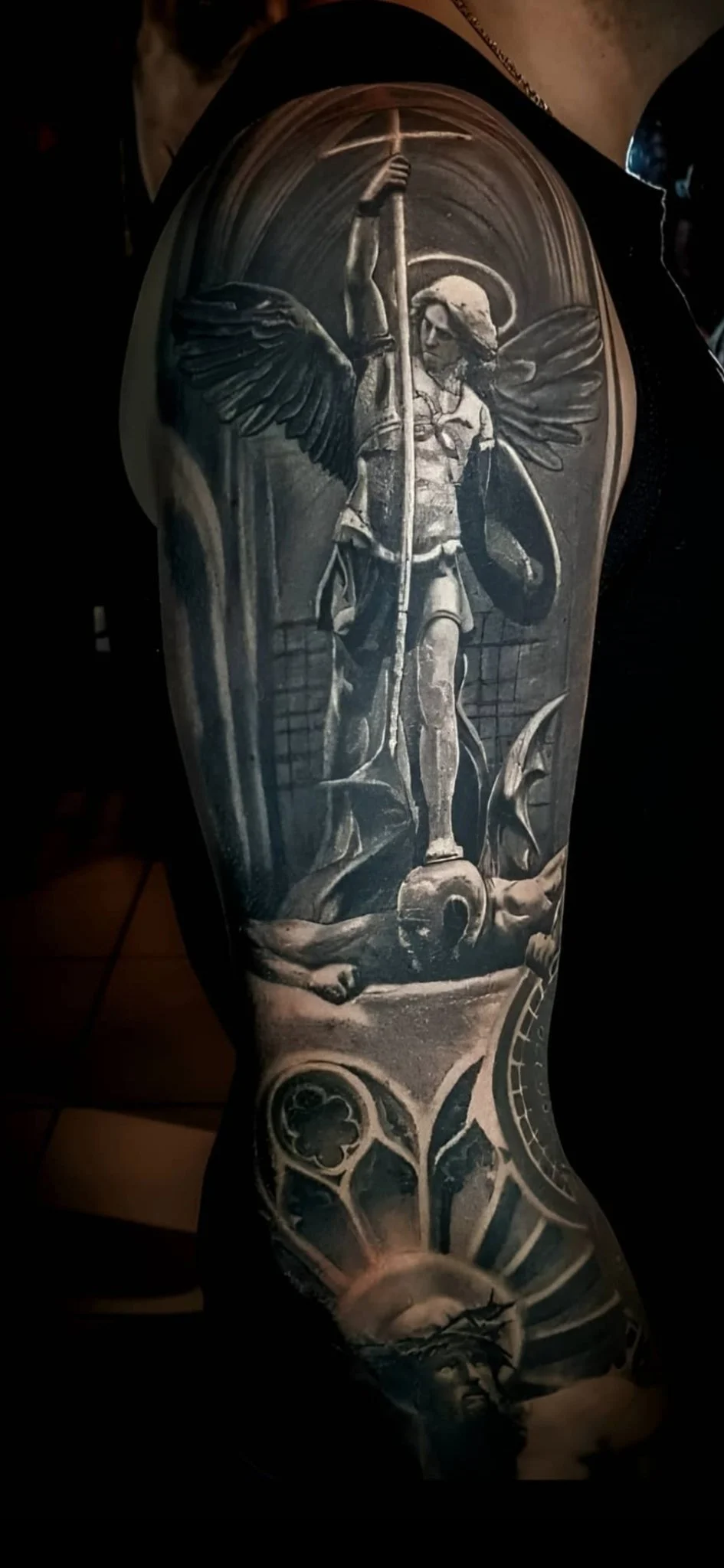 Black and grey realism Archangel Michael sleeve tattoo on upper arm
