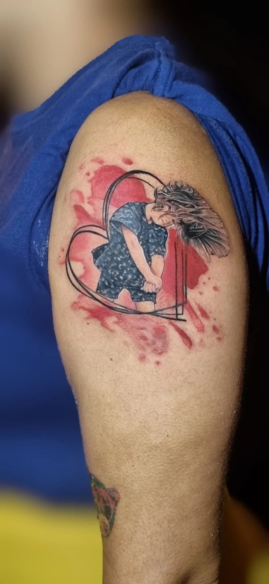Watercolor angel with heart frame tattoo on upper arm