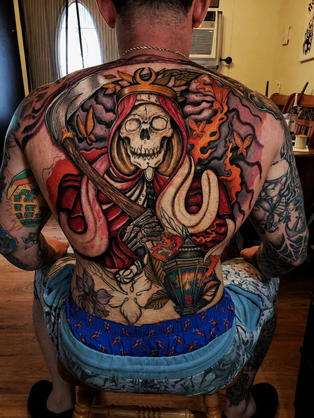 Full back neo-traditional Santa Muerte tattoo with scythe and lantern