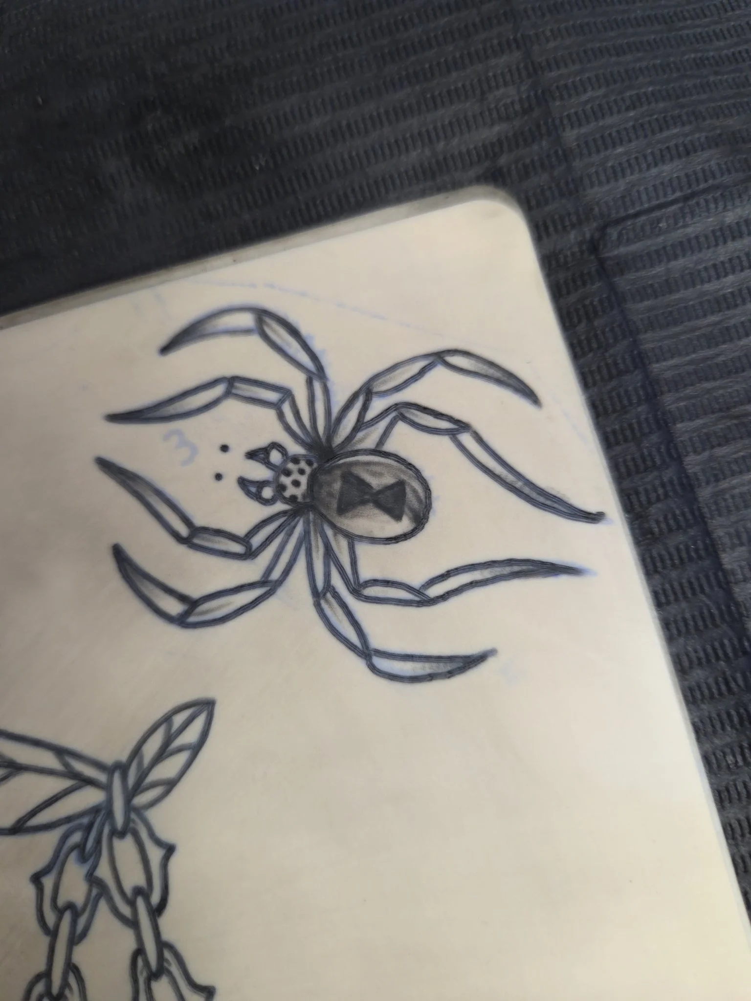 Sketch style spider with bow tie drawing on sketchbook page