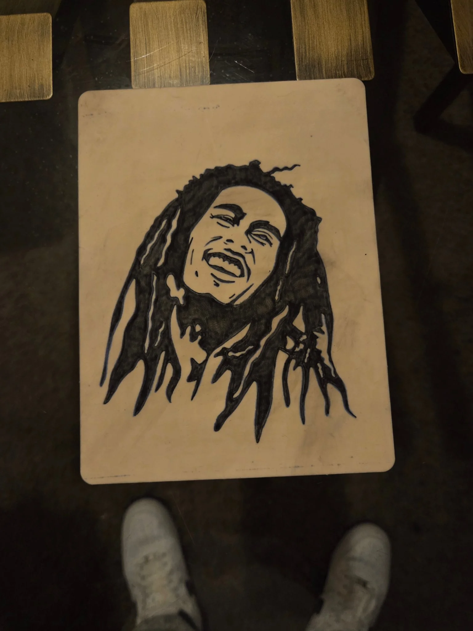 Black illustrative portrait with dreadlocks on flat board