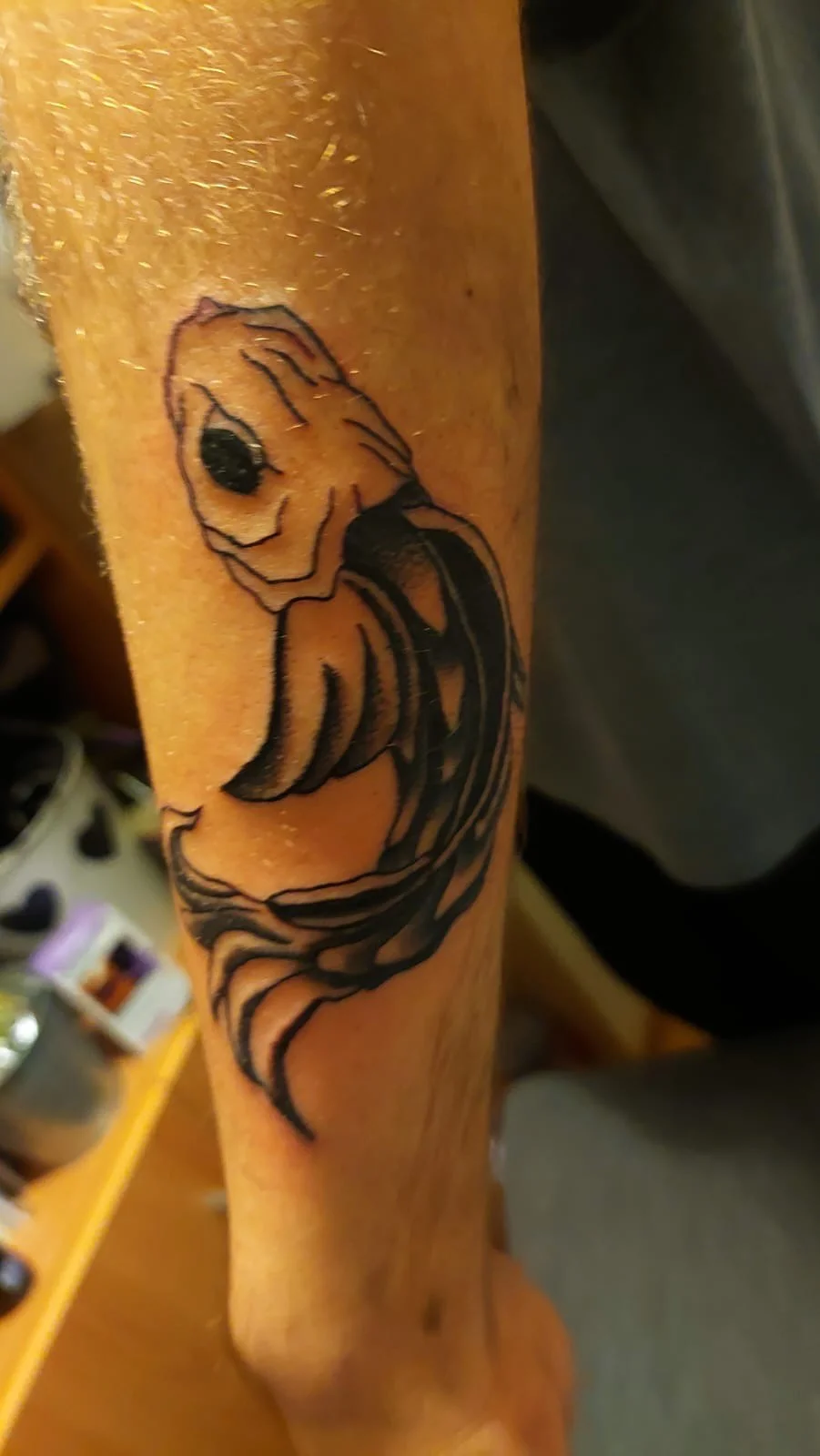 Neo-traditional koi fish tattoo on forearm in black ink