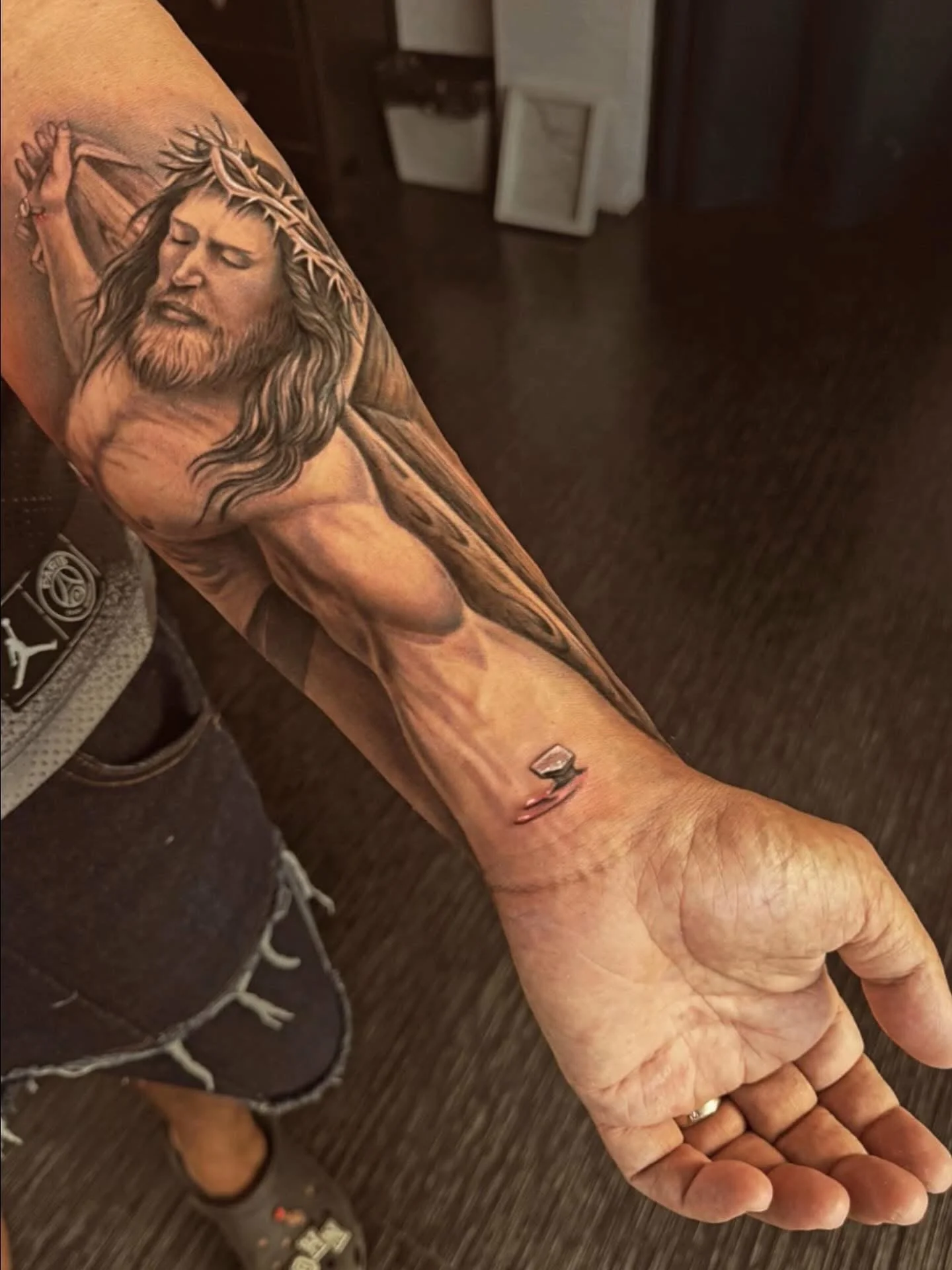 Black and grey realism Jesus crucifixion tattoo on forearm