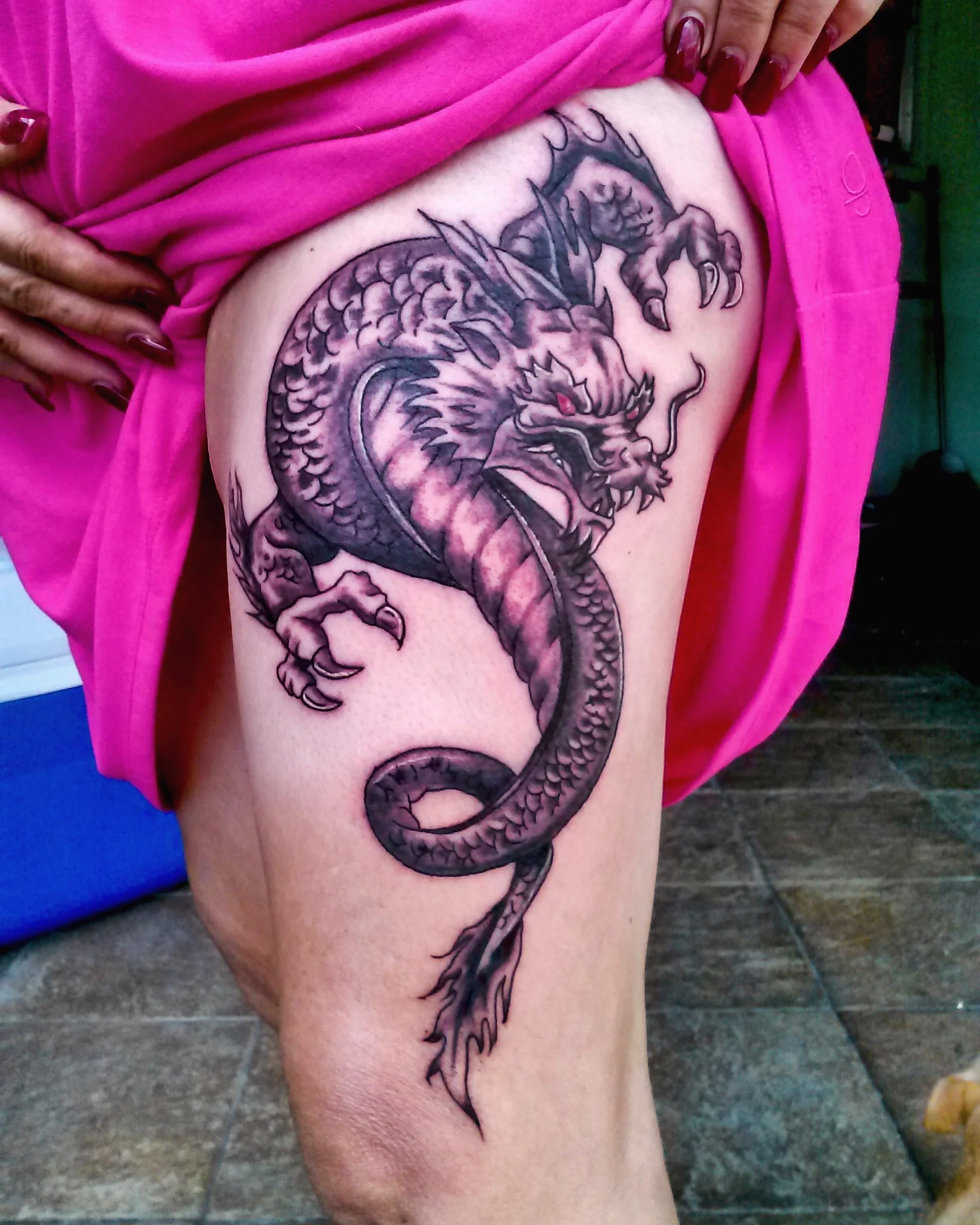 Black and grey Japanese dragon tattoo on upper thigh