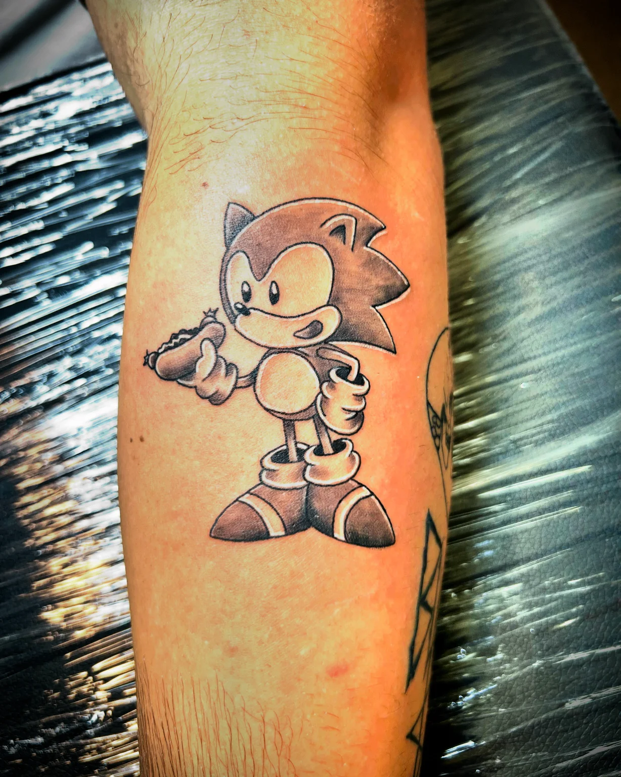 Black and grey classic Sonic the Hedgehog tattoo on forearm