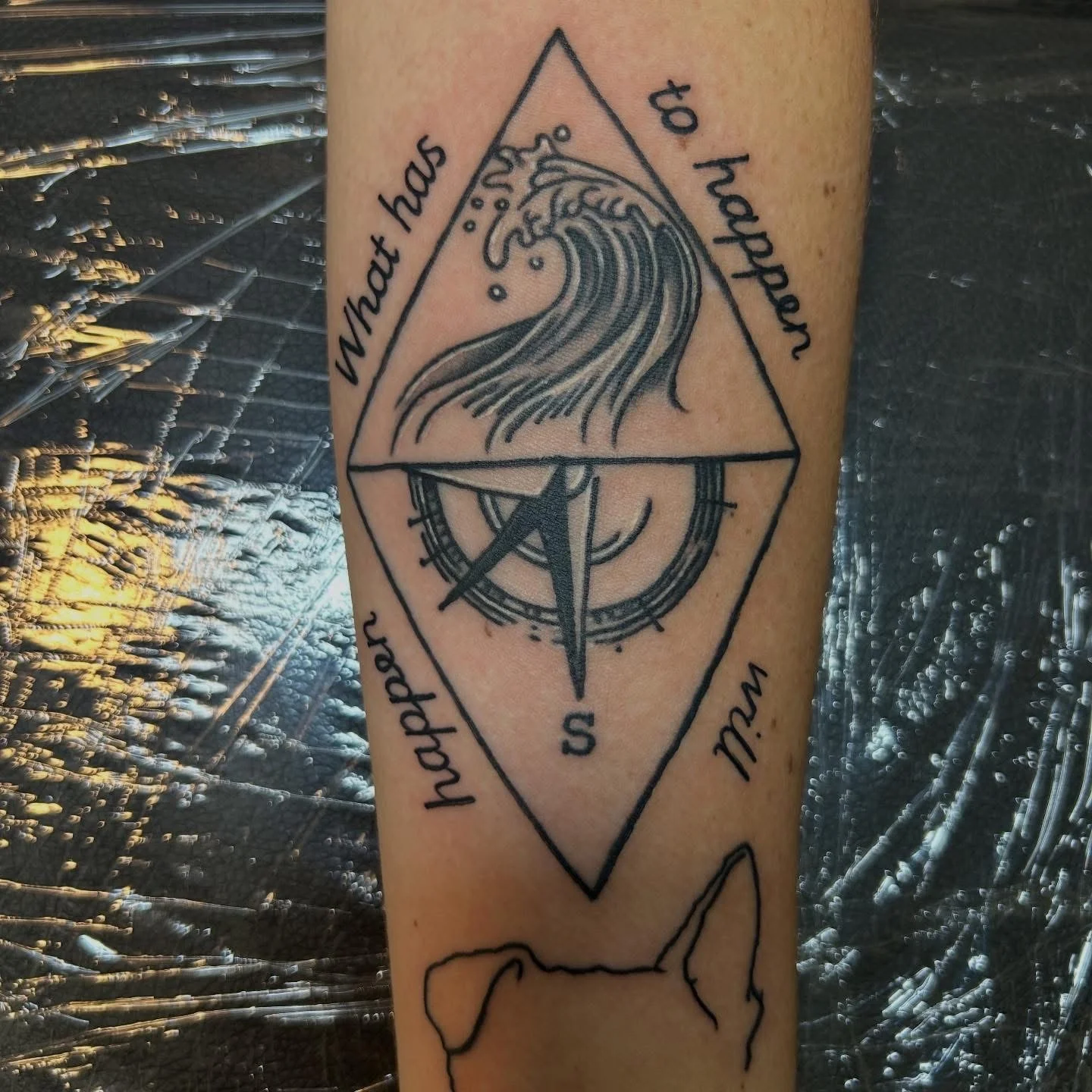 Geometric diamond tattoo with wave, compass, and script on forearm