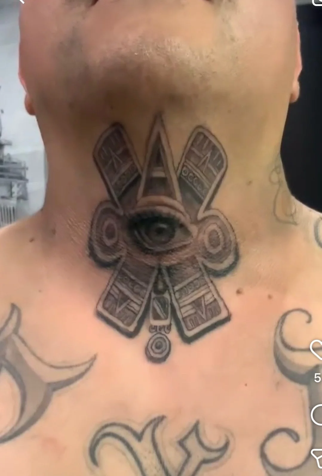 Black and grey all-seeing eye cross tattoo on neck and chest