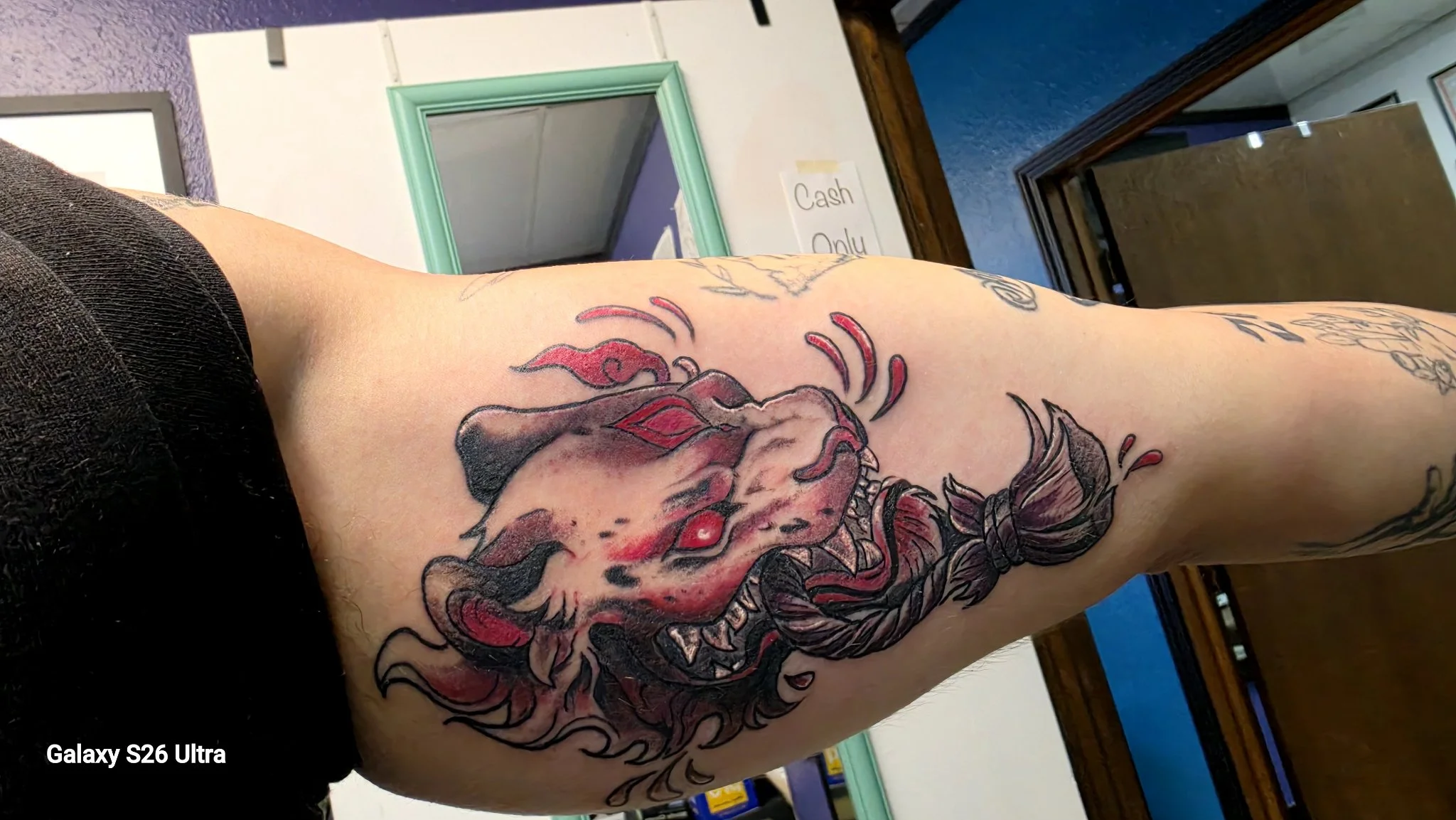 Neo-traditional snarling panther with floral elements on upper arm