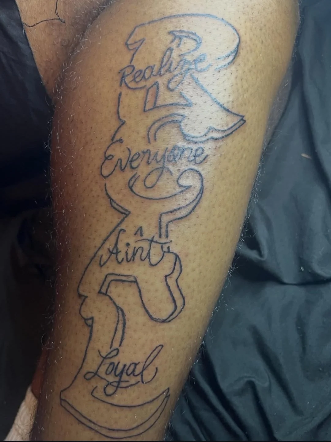 Script lettering tattoo with anchor outline on forearm