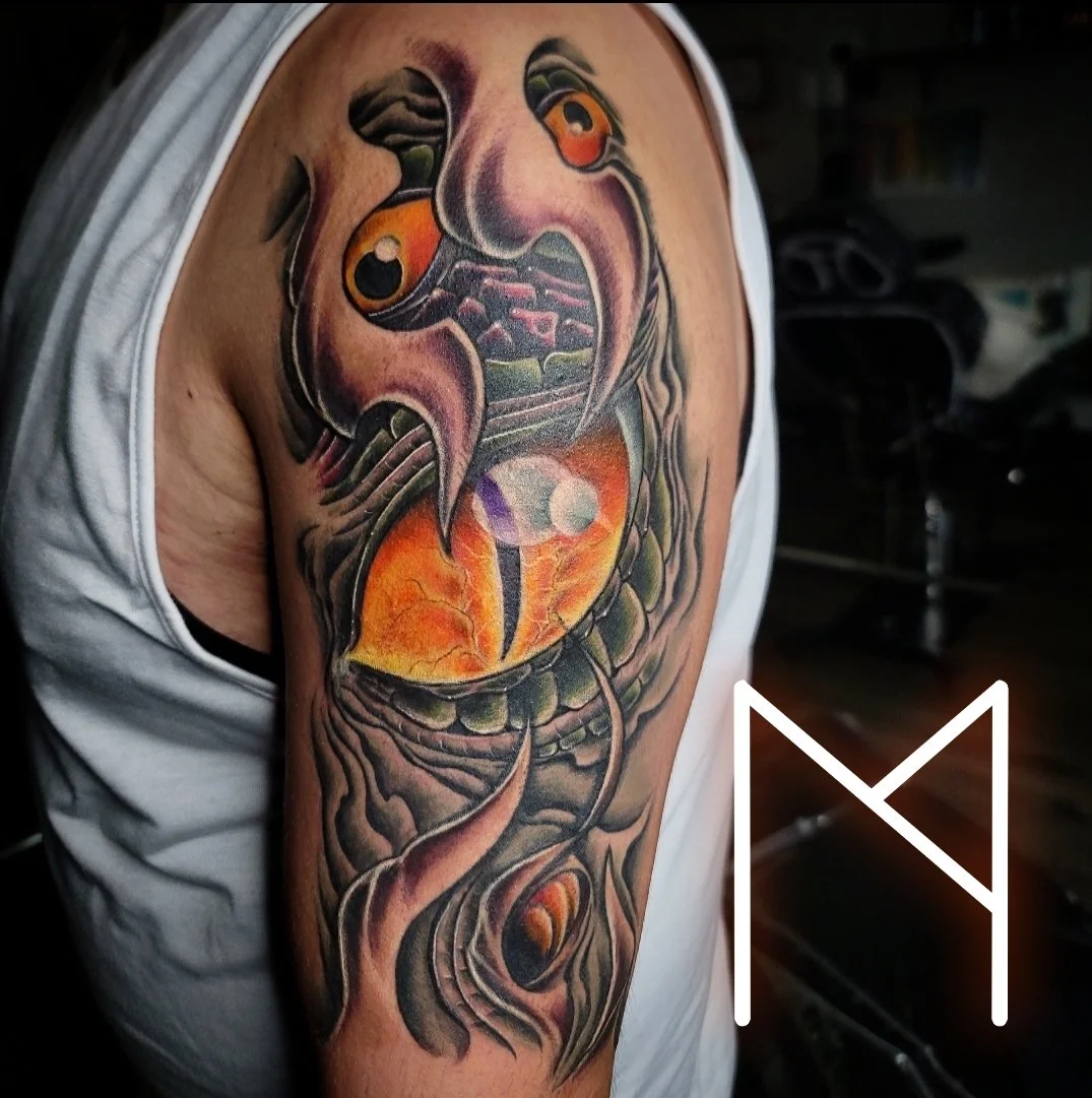 Vibrant neo-traditional koi fish tattoo on upper arm