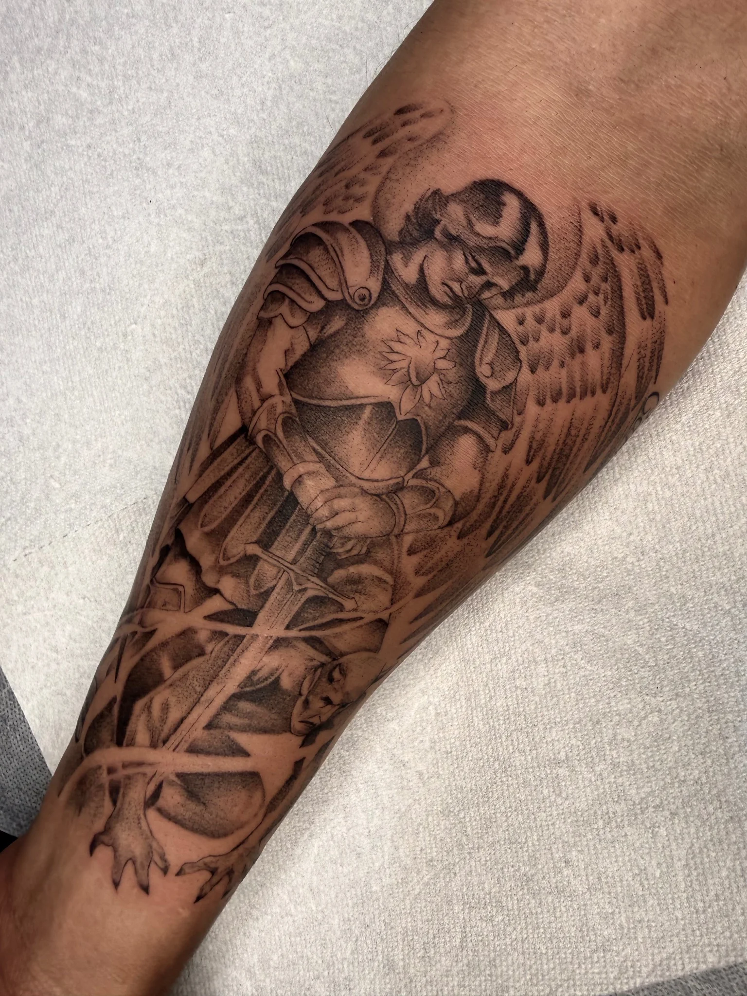 Black and grey archangel warrior tattoo on forearm