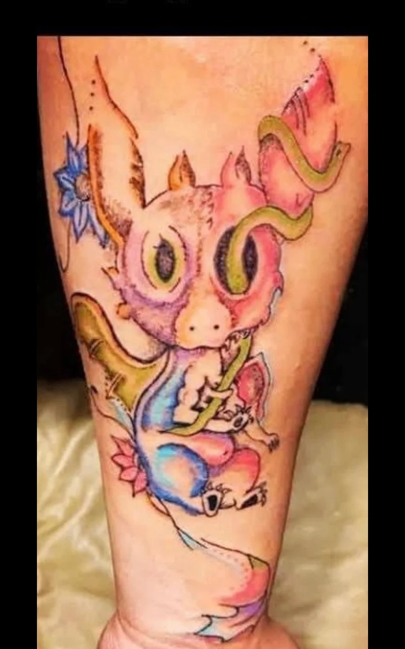 Colorful new school baby dragon tattoo on forearm