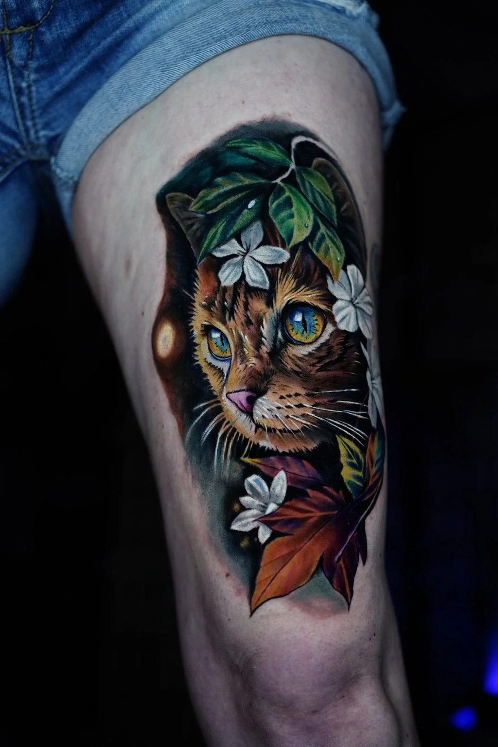Color realism cat portrait with florals and foliage on thigh