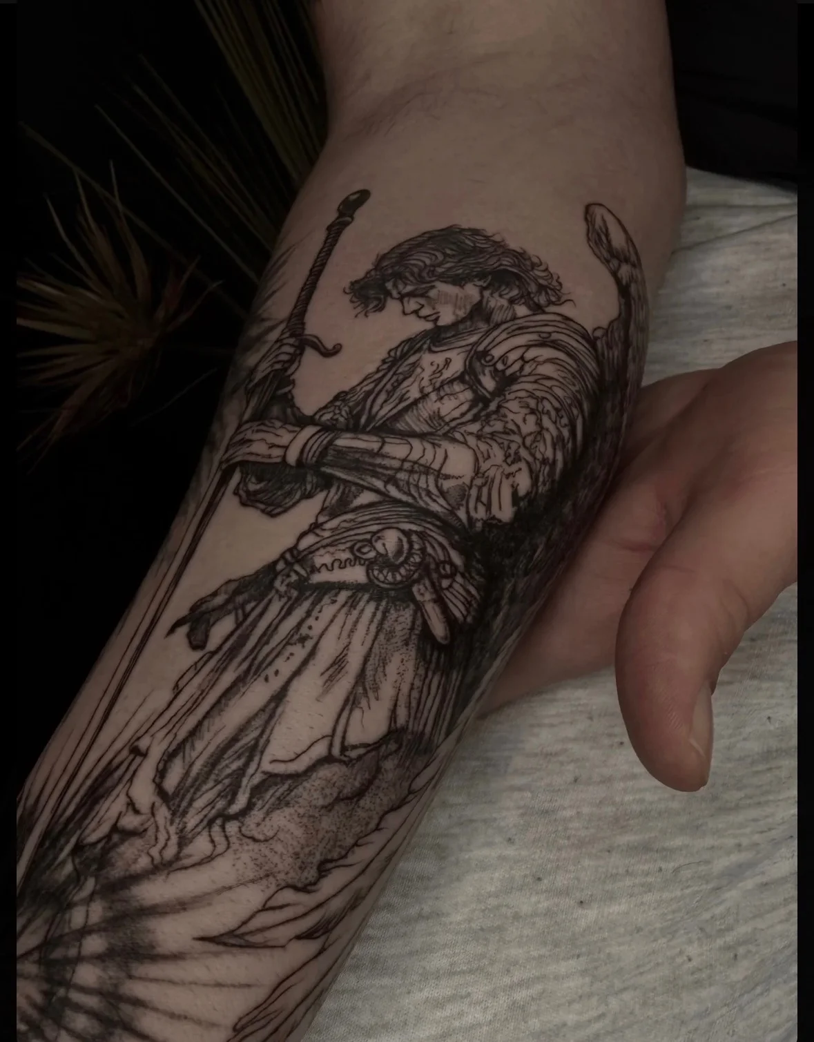 Illustrative armored warrior with sword tattoo on forearm