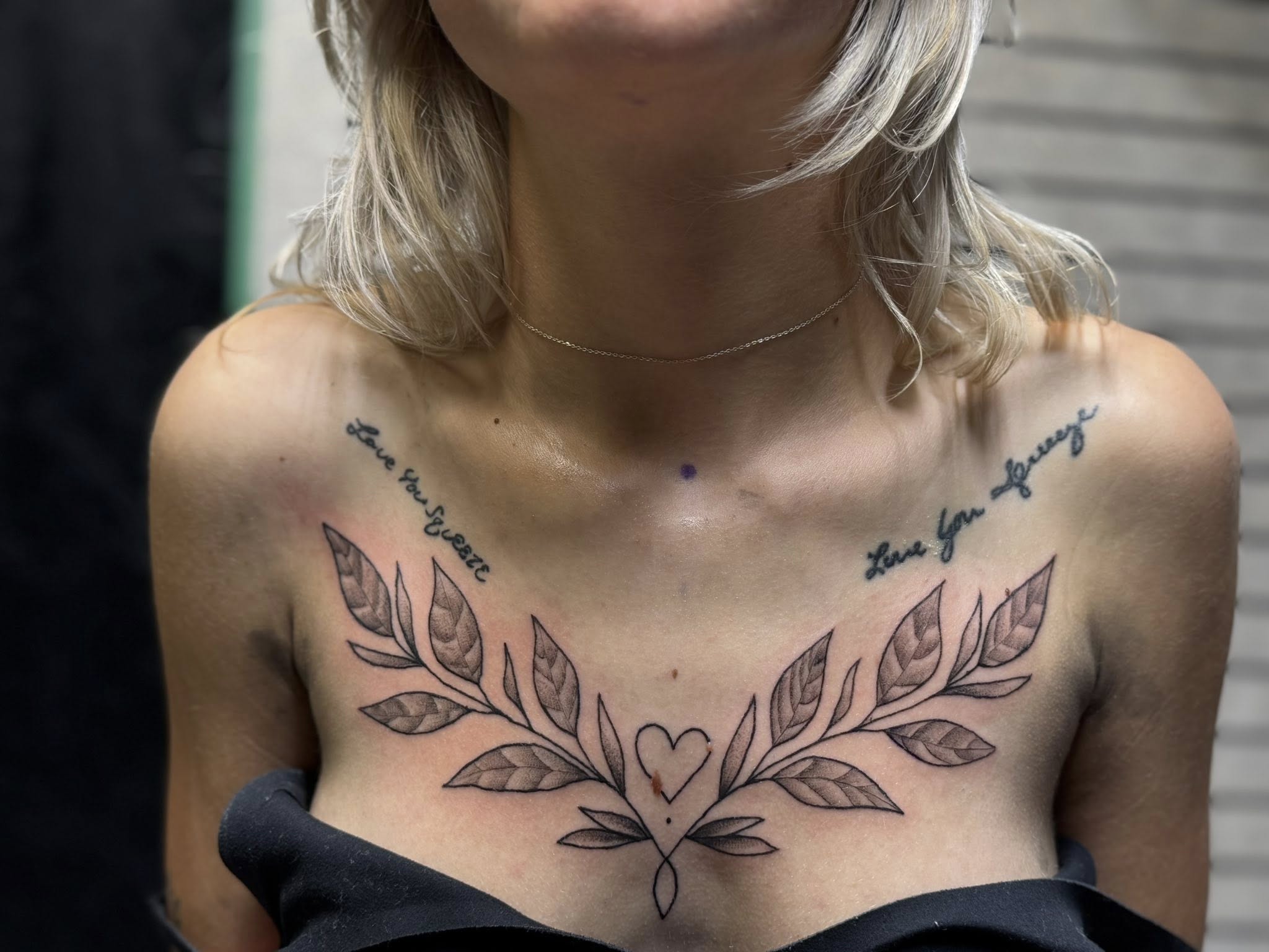 Fine line botanical leaf wreath with heart and script text on chest