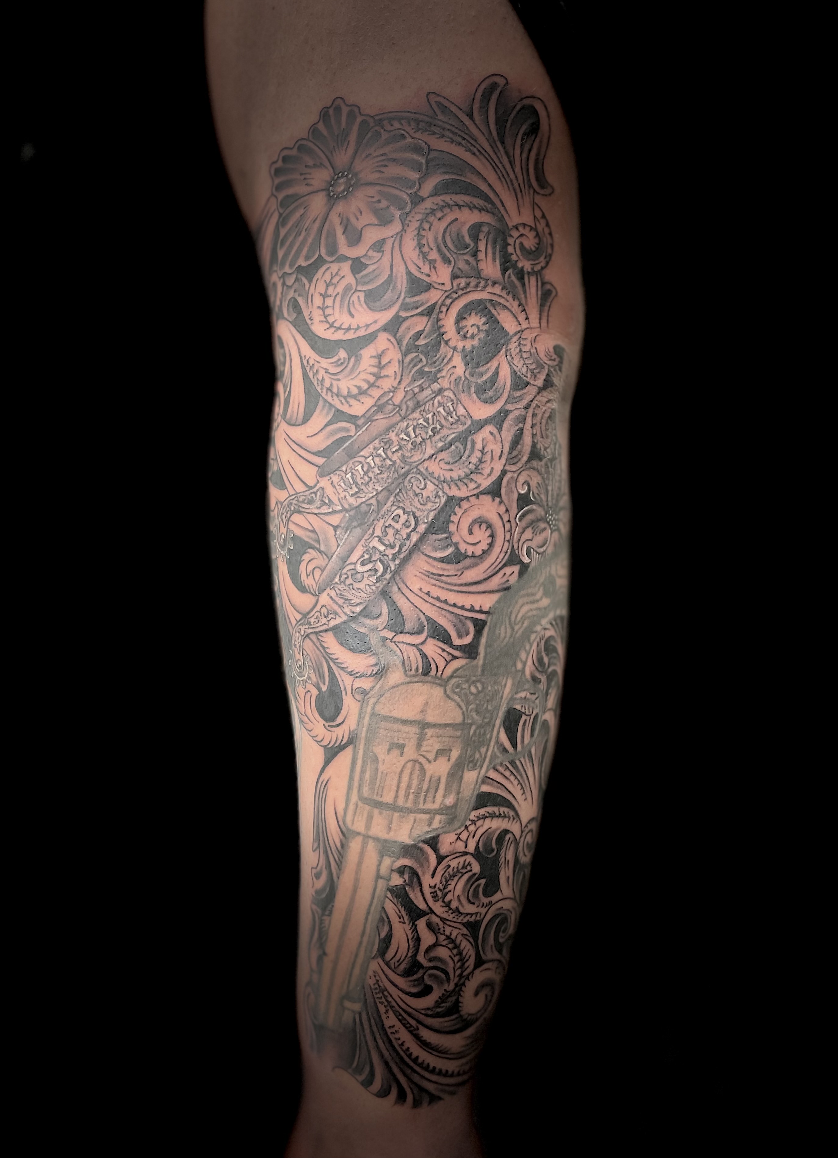 Ornamental baroque skull and floral full leg sleeve in black and grey
