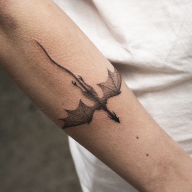 Fine line swallow bird tattoo on forearm