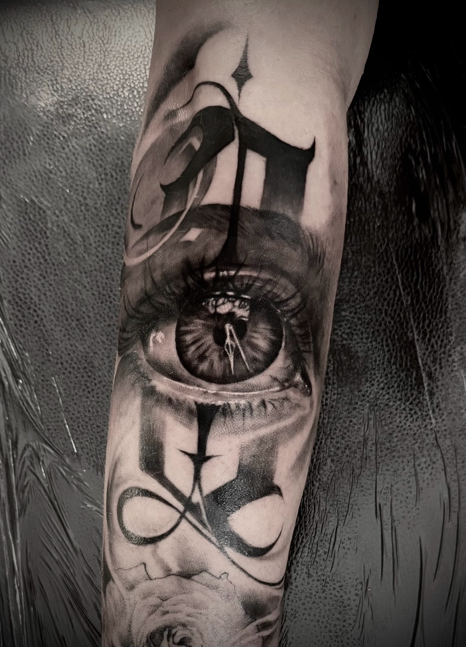 Realistic eye with surreal elements on forearm sleeve tattoo