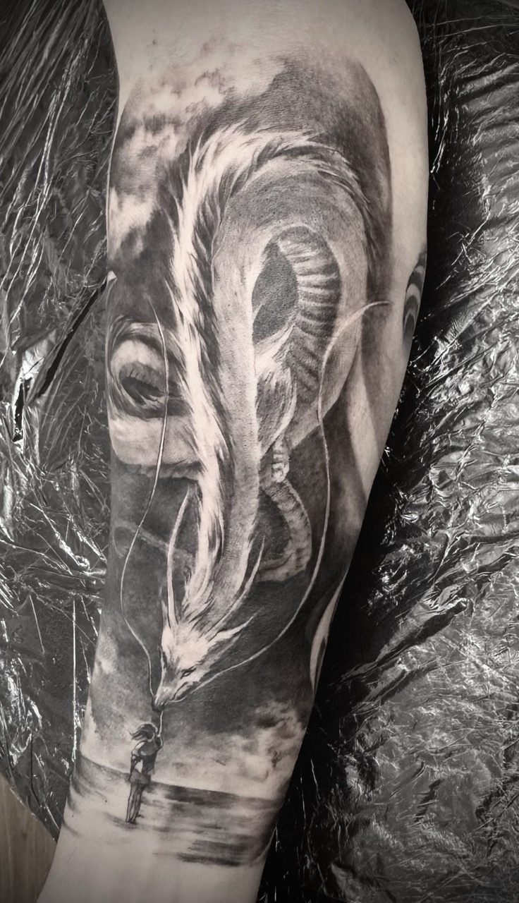 Black and grey realism alien portrait with human figure on upper arm sleeve